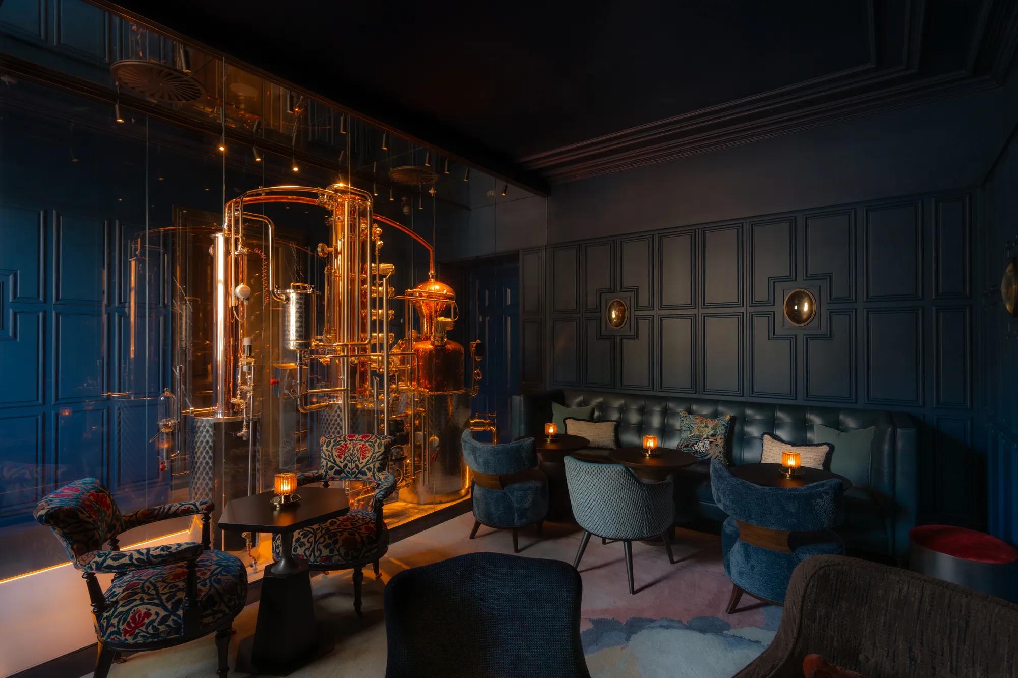 A man in a suit is pouring red wine from a  bottle into a glass.