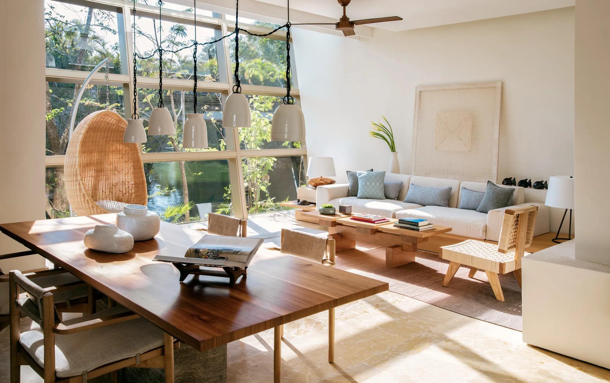 Rosewood Mayakoba - Lagoon-view living room with a hanging rattan chair