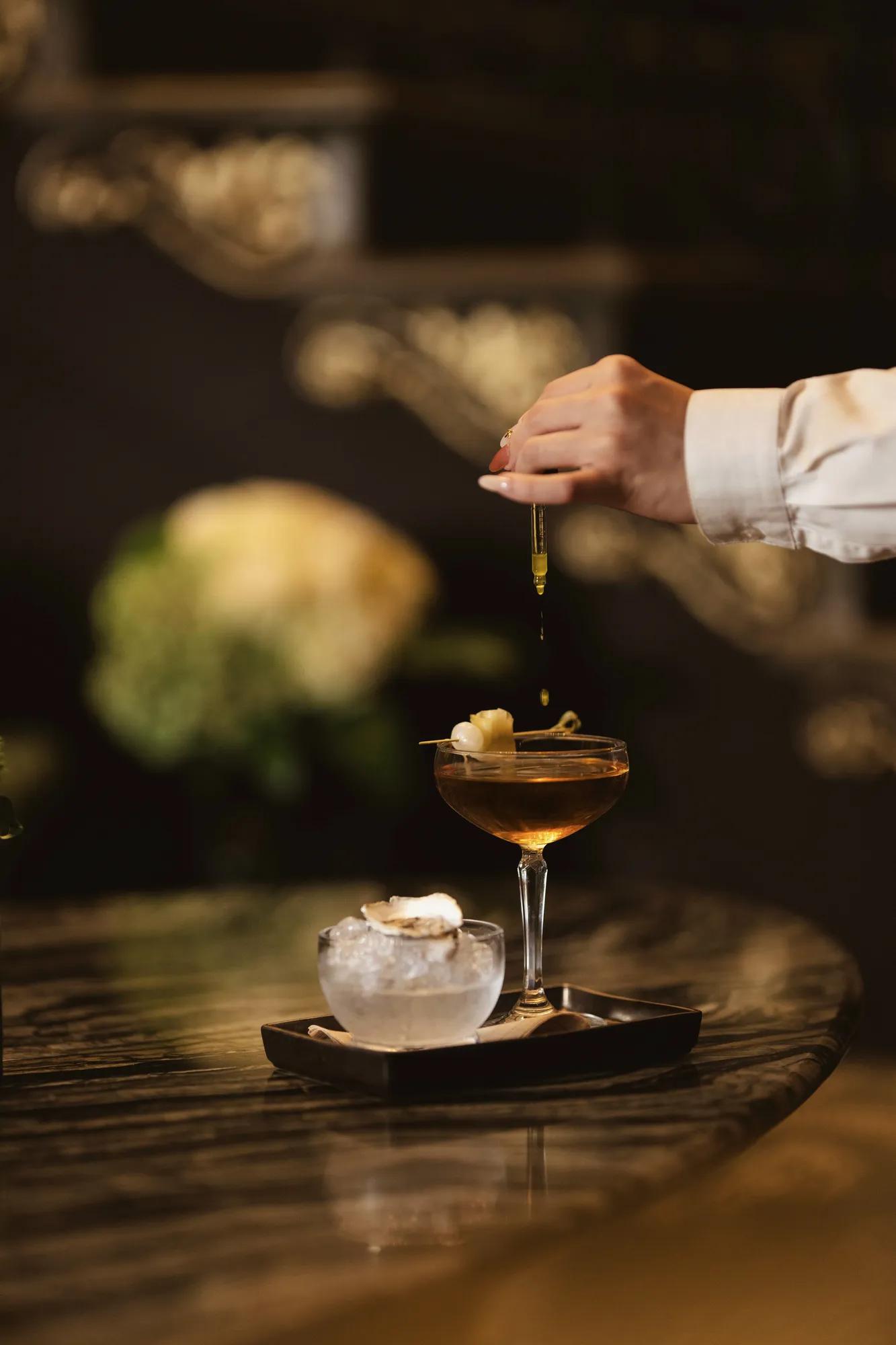 Bartender adding flavours to the drink