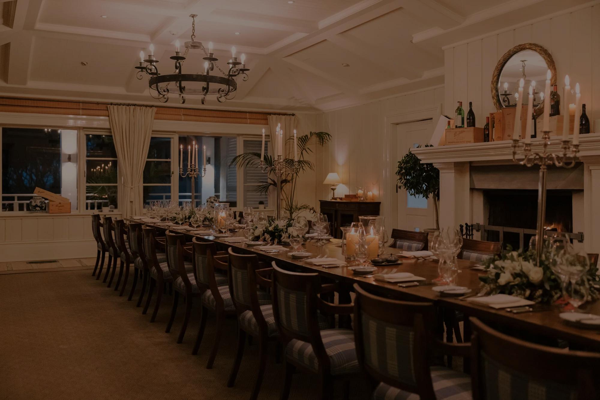 Event dining set up at Rosewood Kauri Cliffs, with one beautifully set long table. 