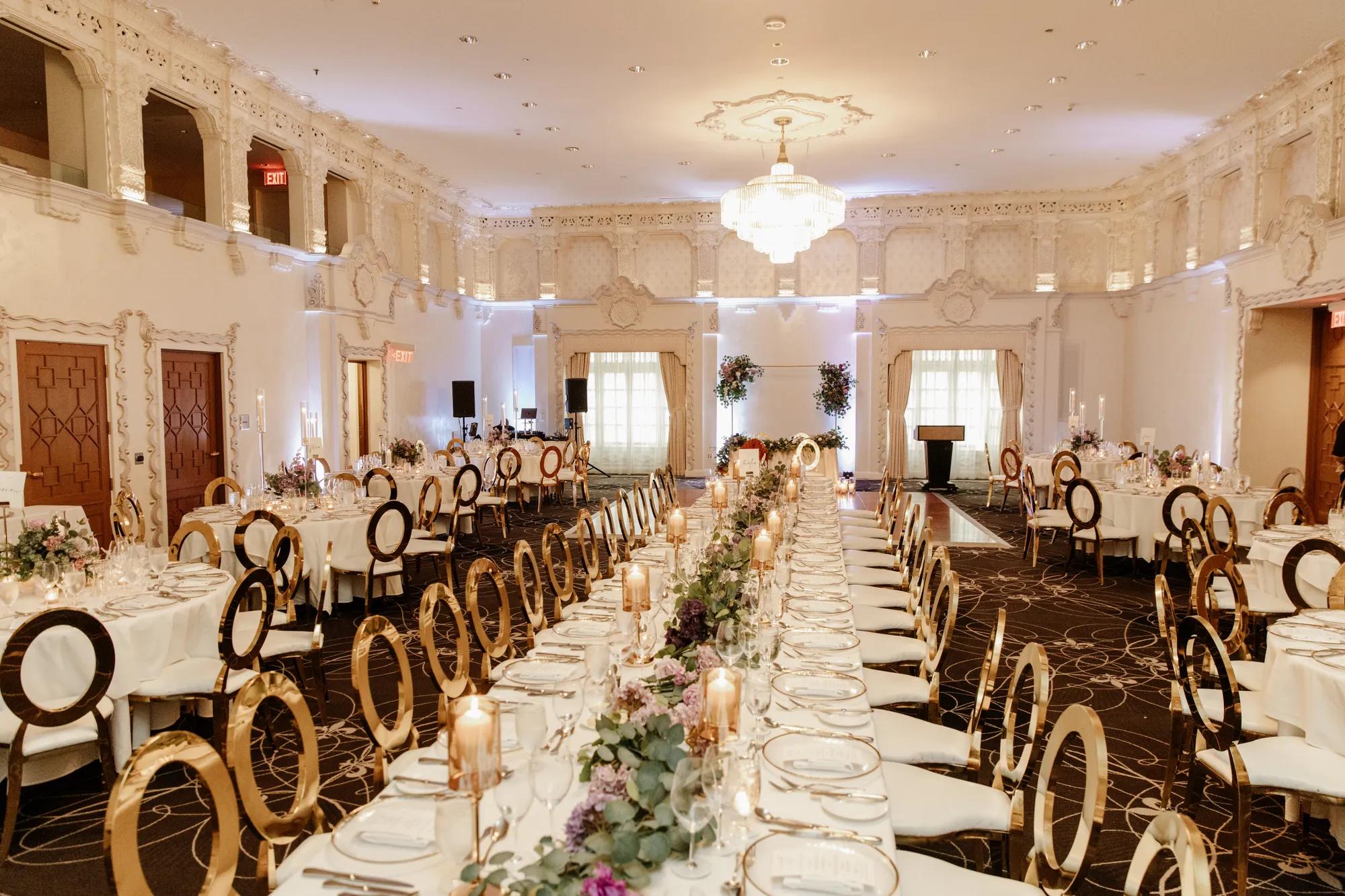 Large Ballroom with long table and chairs with a wedding style decor