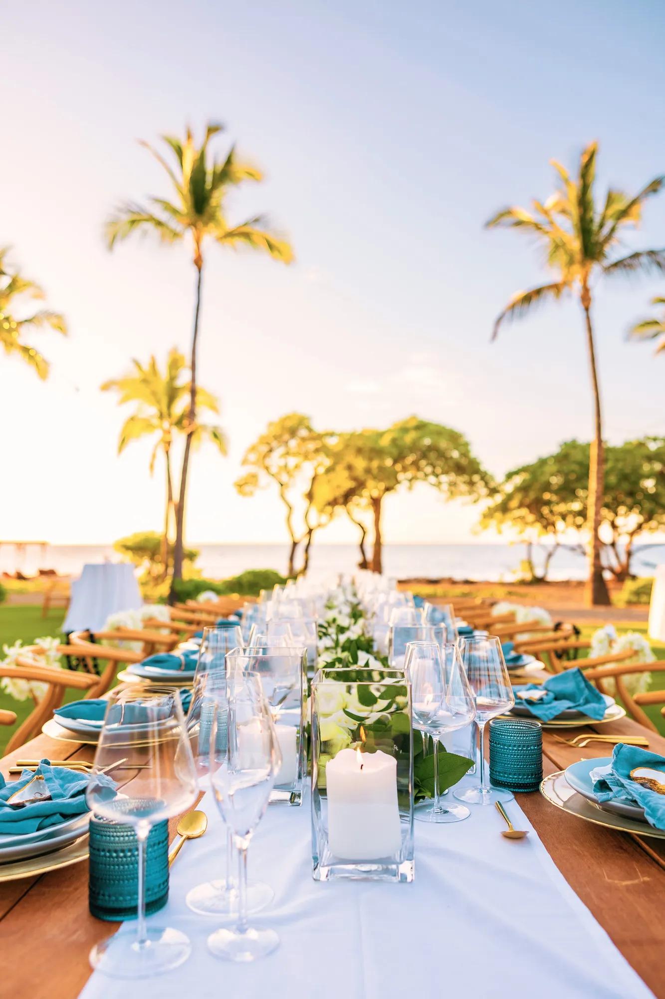 Long table set for an event with the ocean in the background