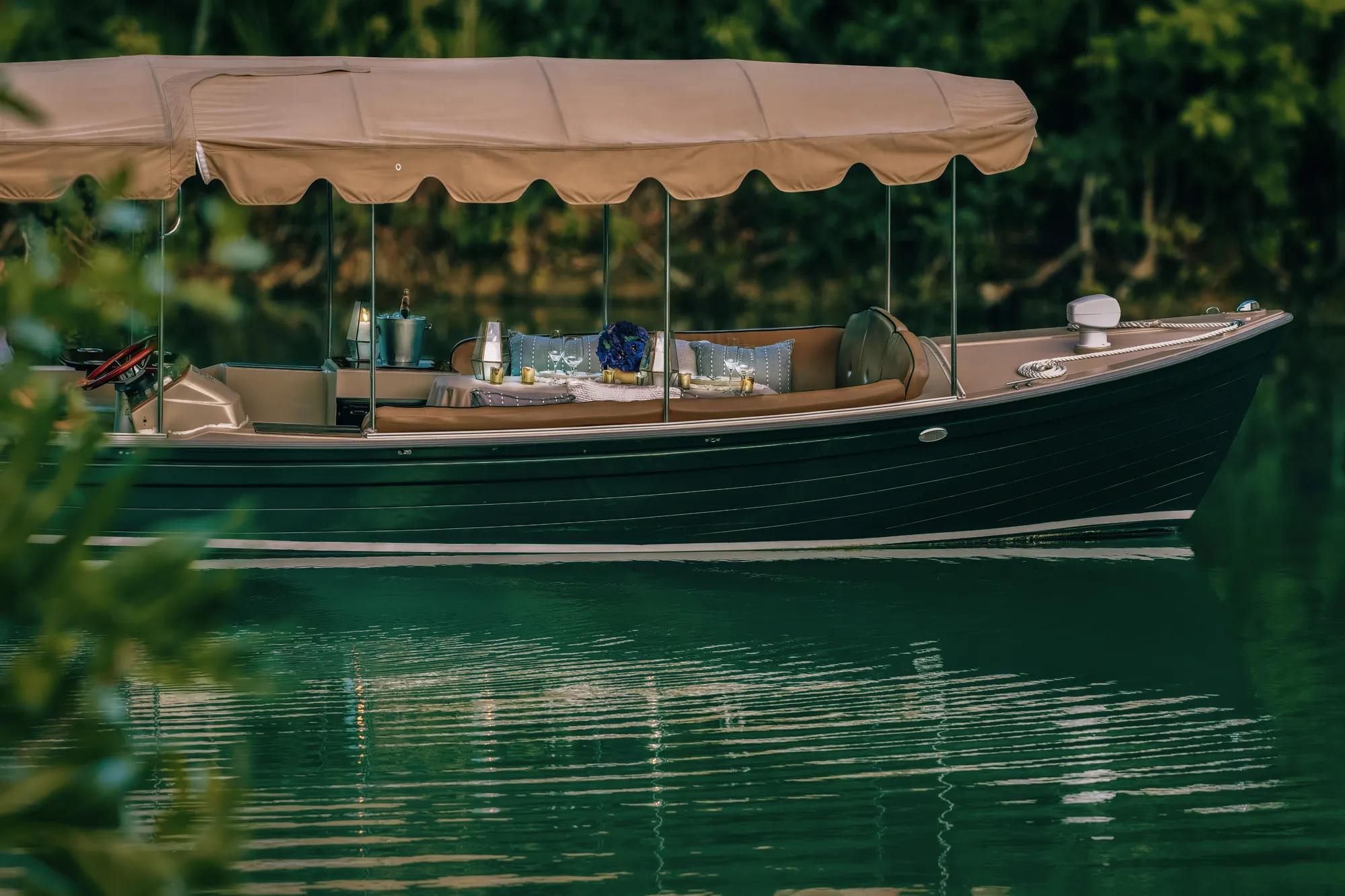 - Private beachfront dinner setup at sunset, with a purple-pink sky casting a warm glow over the ocean and table arrangement.
