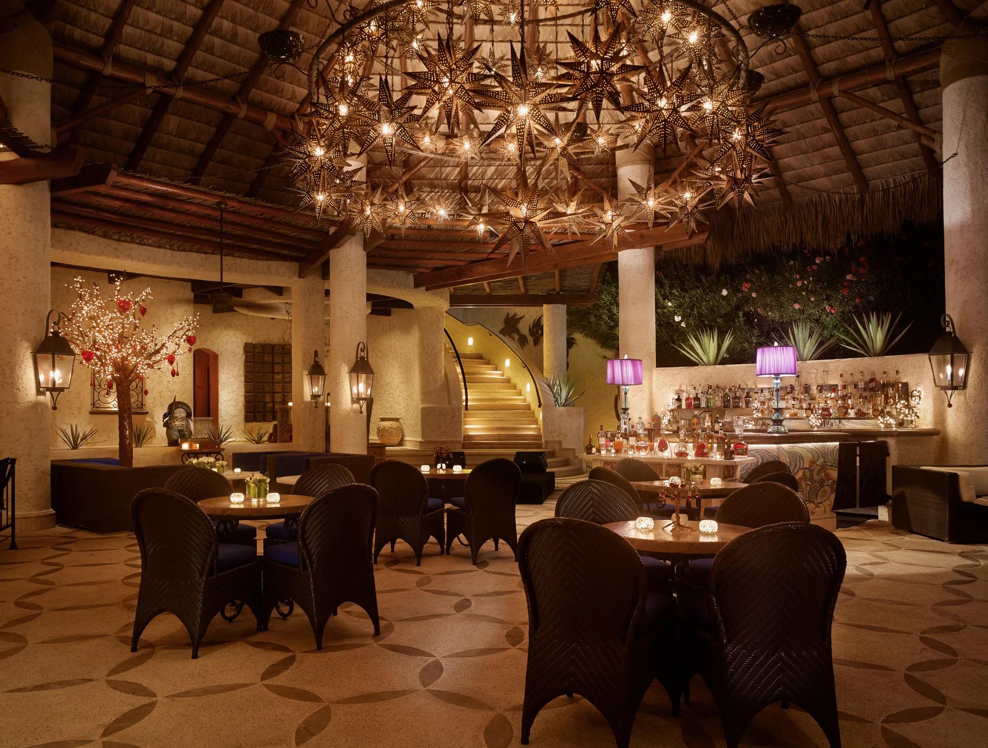 Stylish lounge bar at Alebrije with modern seating, ambient lighting, and a vibrant, colorful décor inviting guests to relax and enjoy drinks.