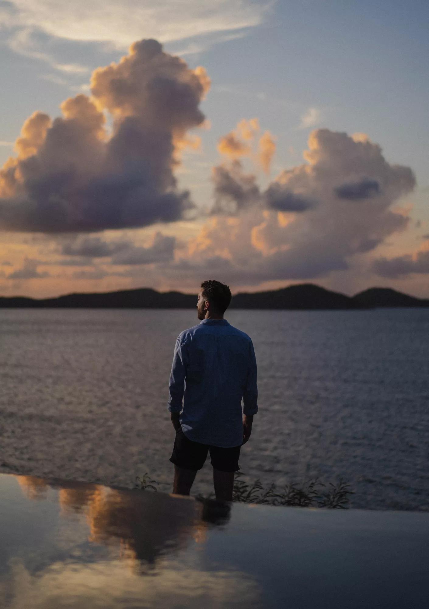 Man looking out at sunset