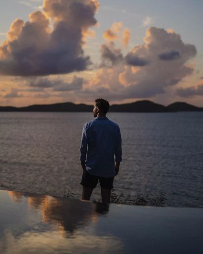 Man looking out at sunset