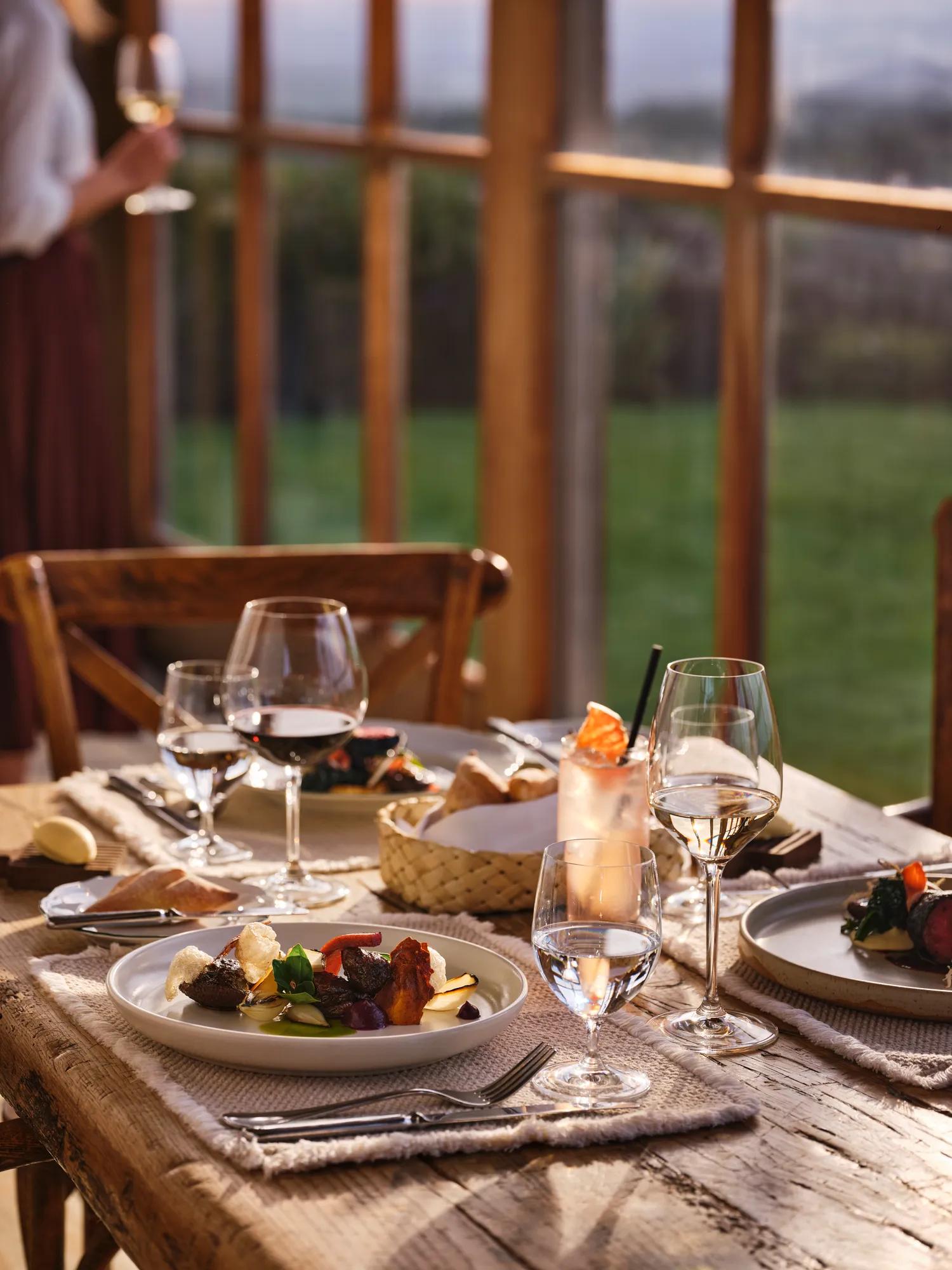 Beautifully set up dining set up in the Loggia at golden hour