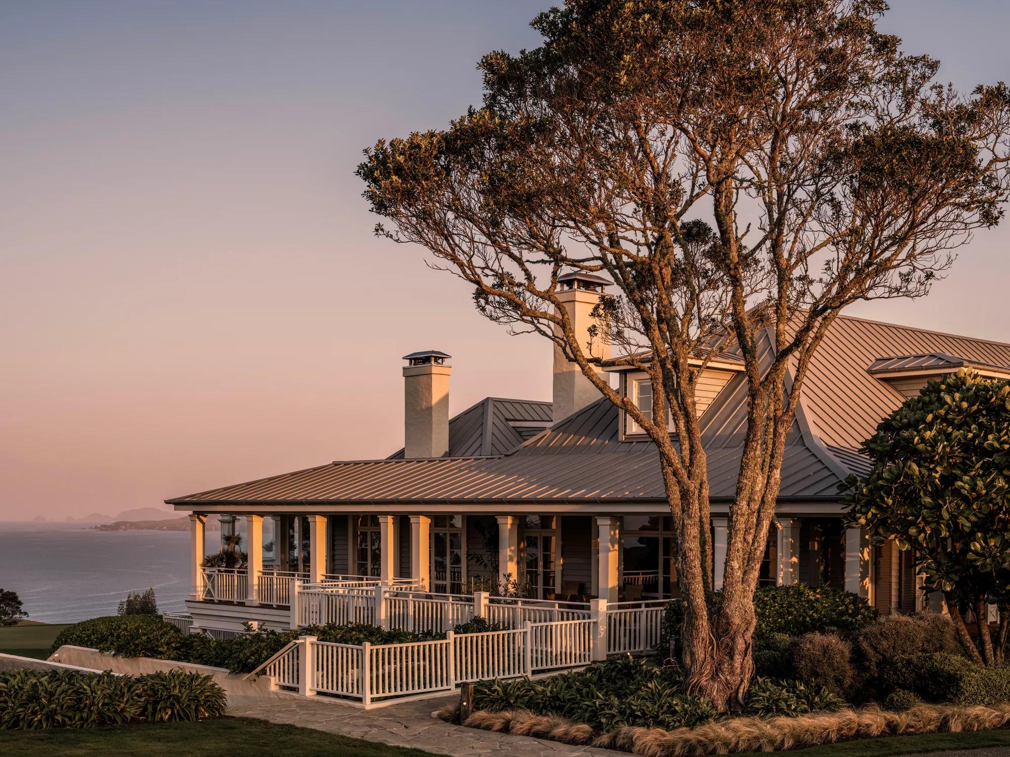 Exterior view of the lodge at Kauri Cliffs at sunset
