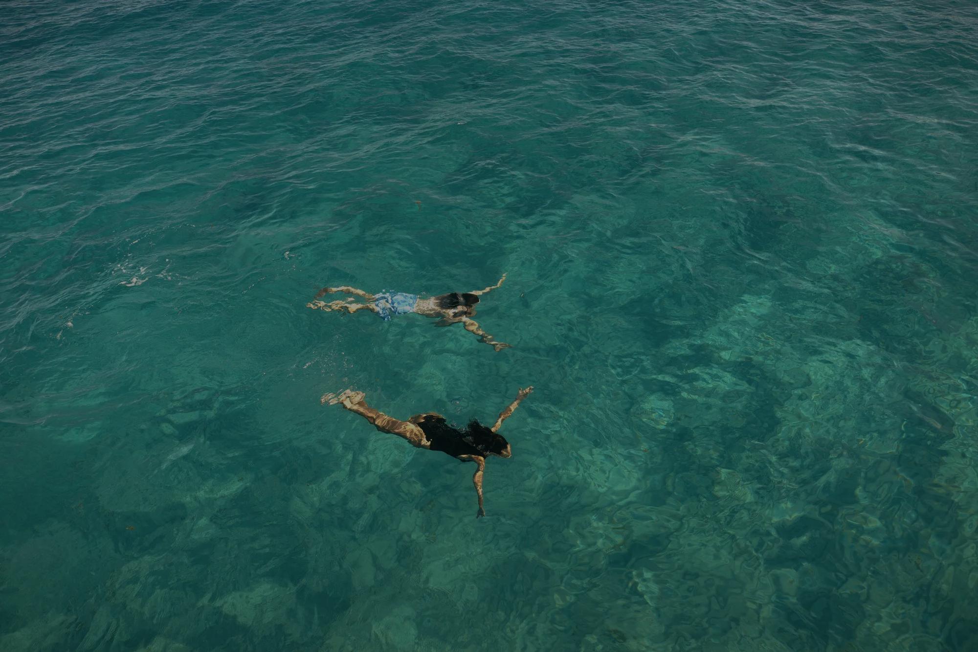 Two women swimming in the ocean