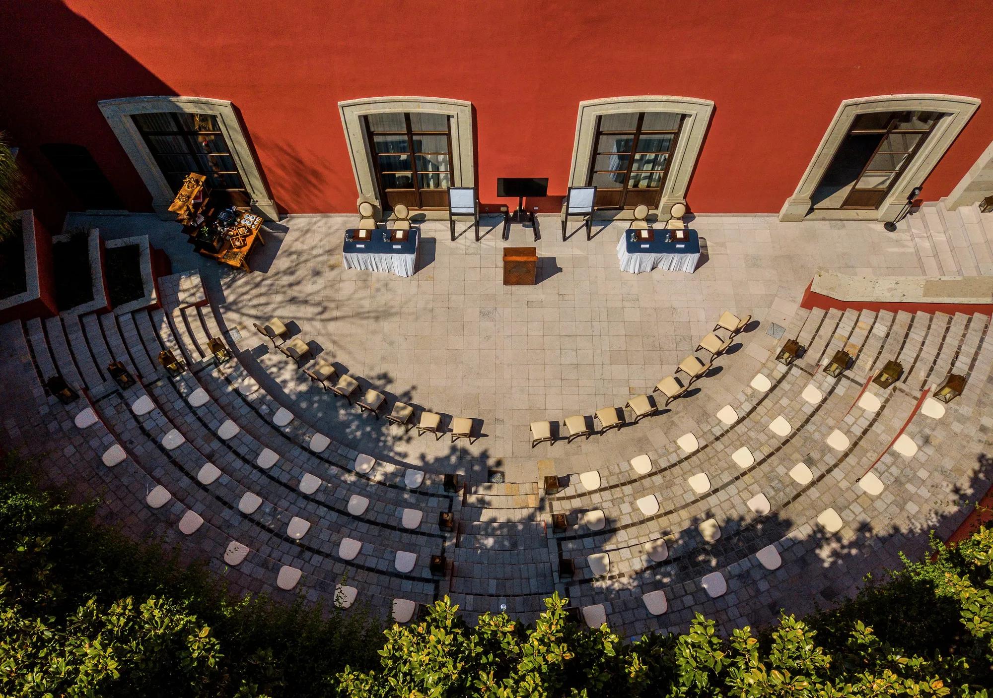 Outdoor amphitheater with four tiered seating levels, each set with cushions for comfort.