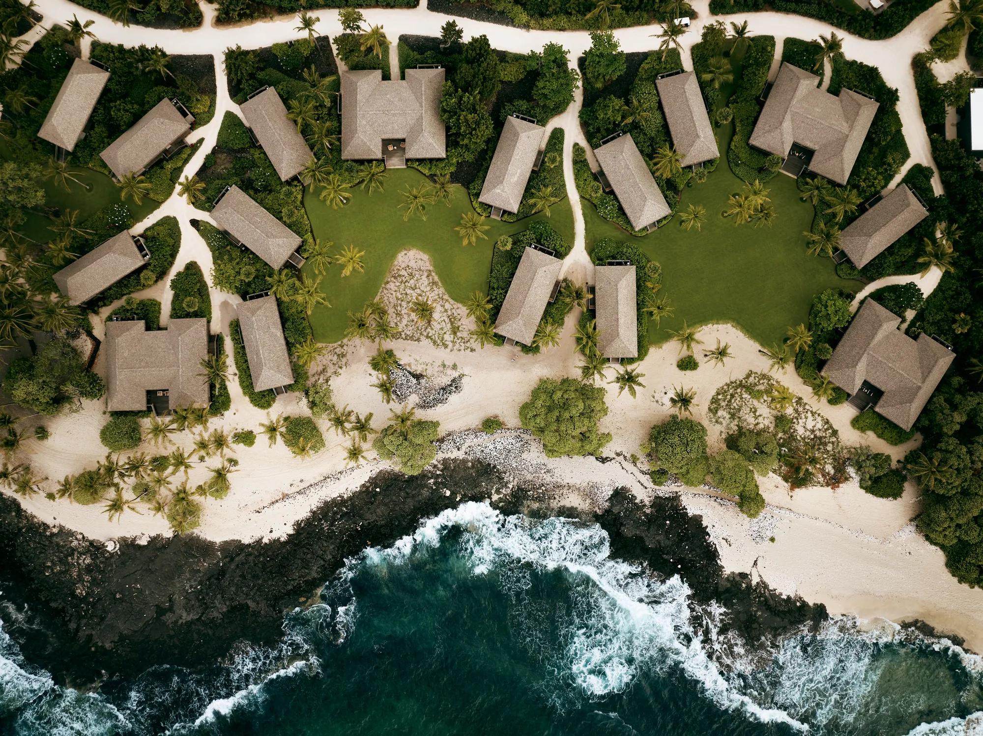 Aerial view of bungalow structures on the coastline