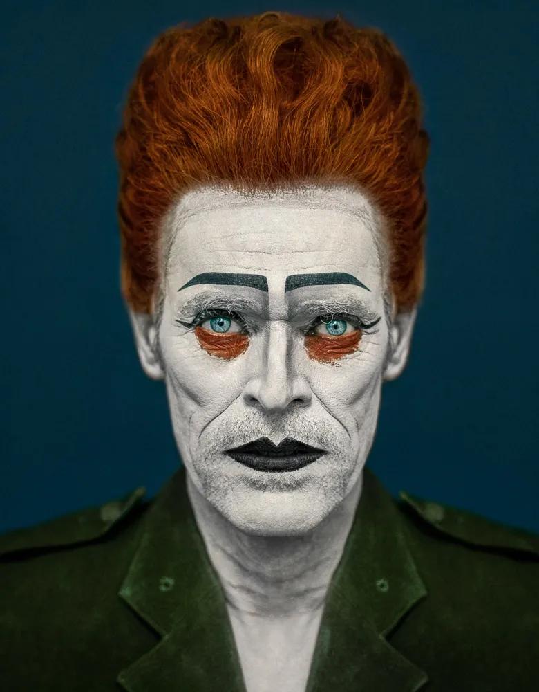 Painting of face of a man with red hear