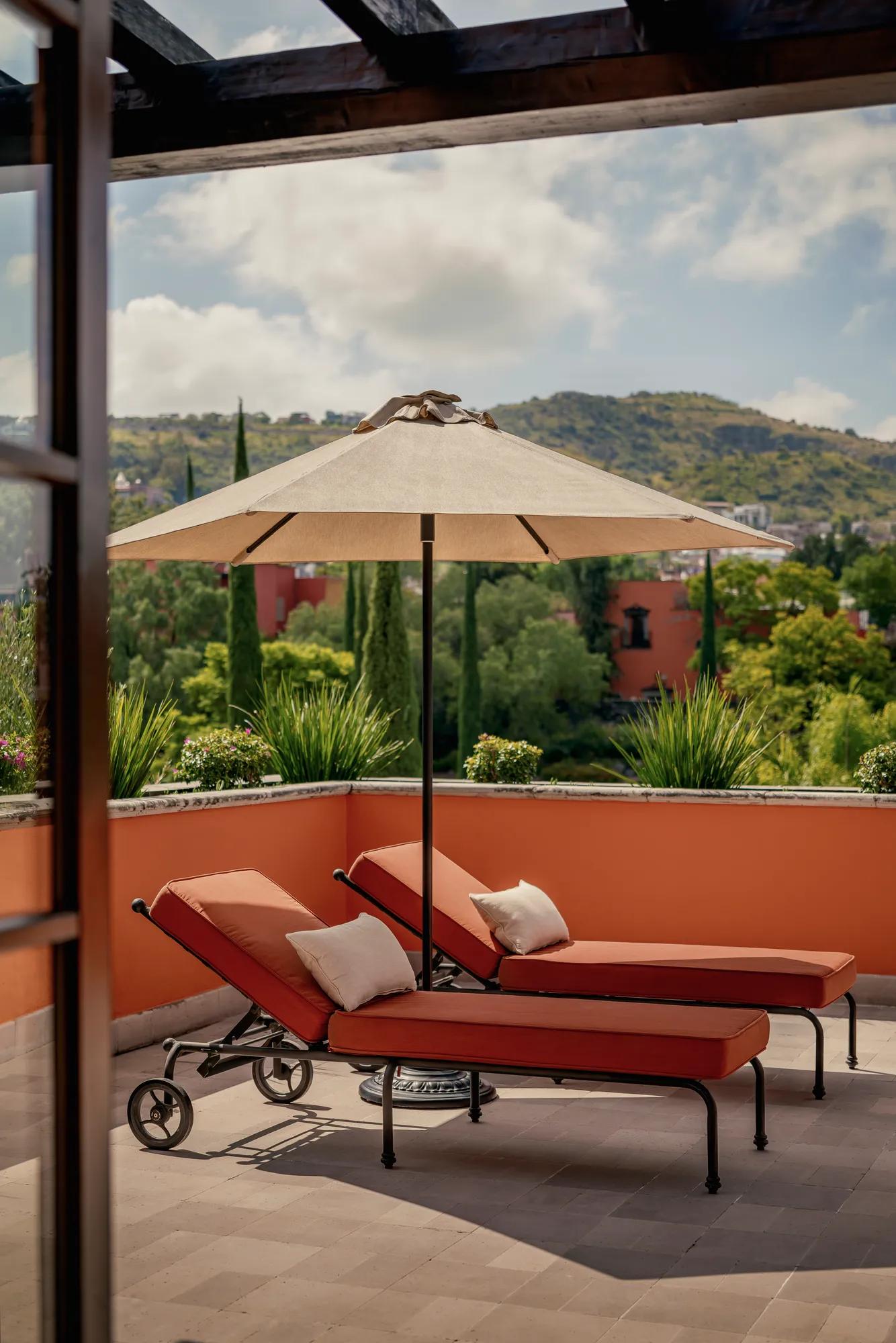 Rooftop Colonial Suite at Rosewood San Miguel de Allende with private terrace, city views, and open-air lounge at sunset.