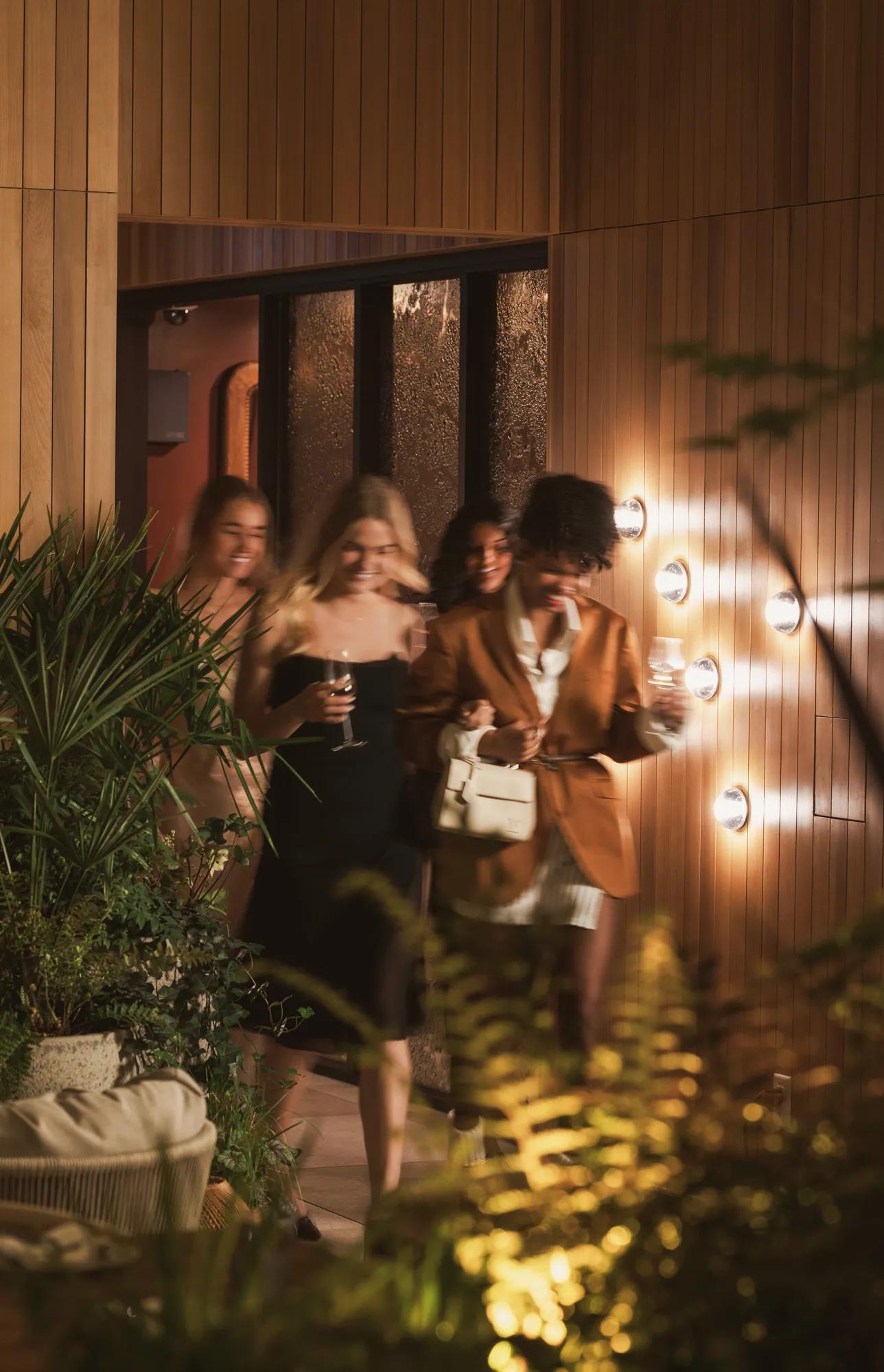 Ladies dressed up holding a cocktail