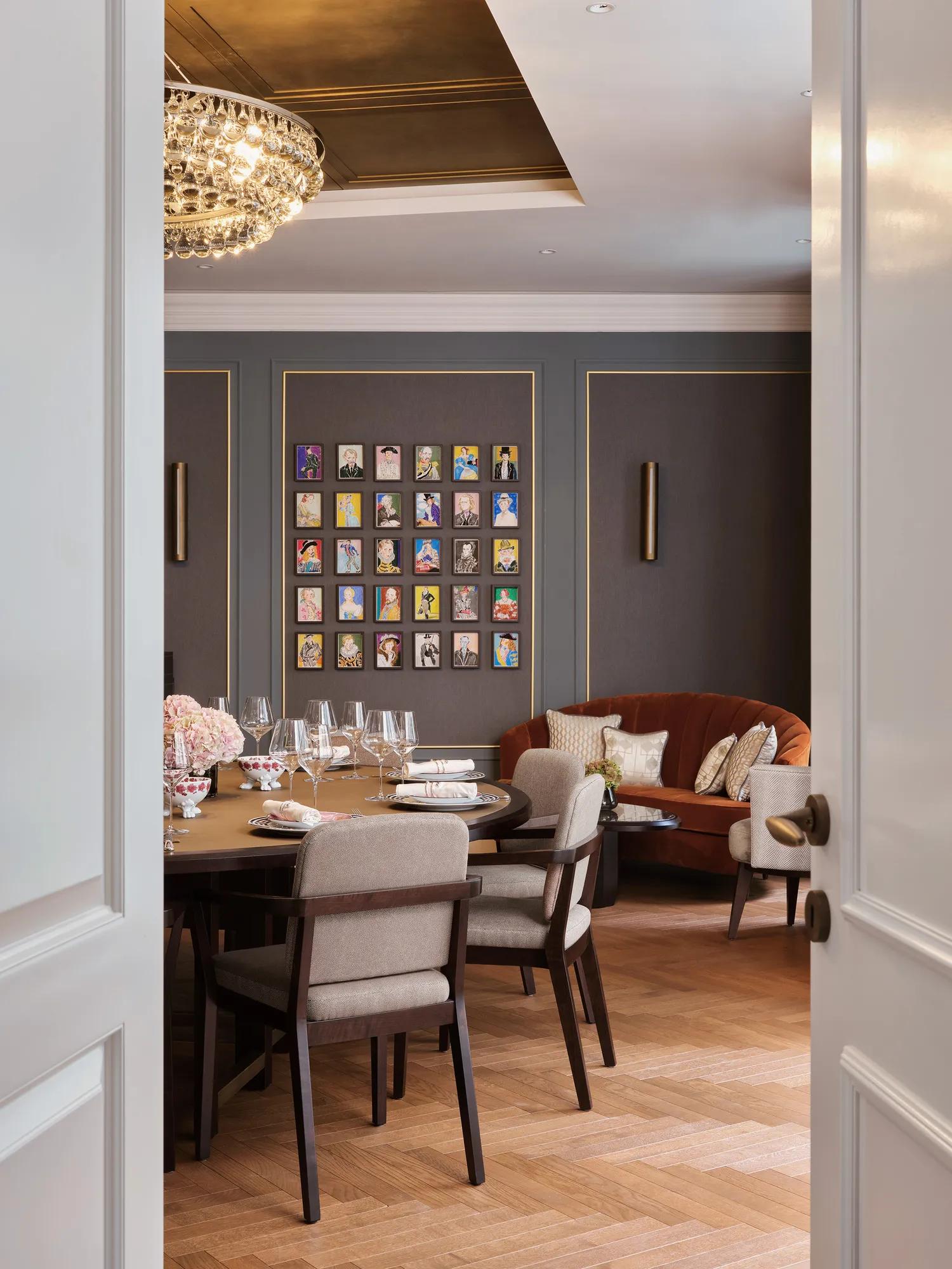 The Den at The Pavilion, an intimate private dining space with a round set table, elegant chandelier, modern artwork, and plush seating in a refined atmosphere.