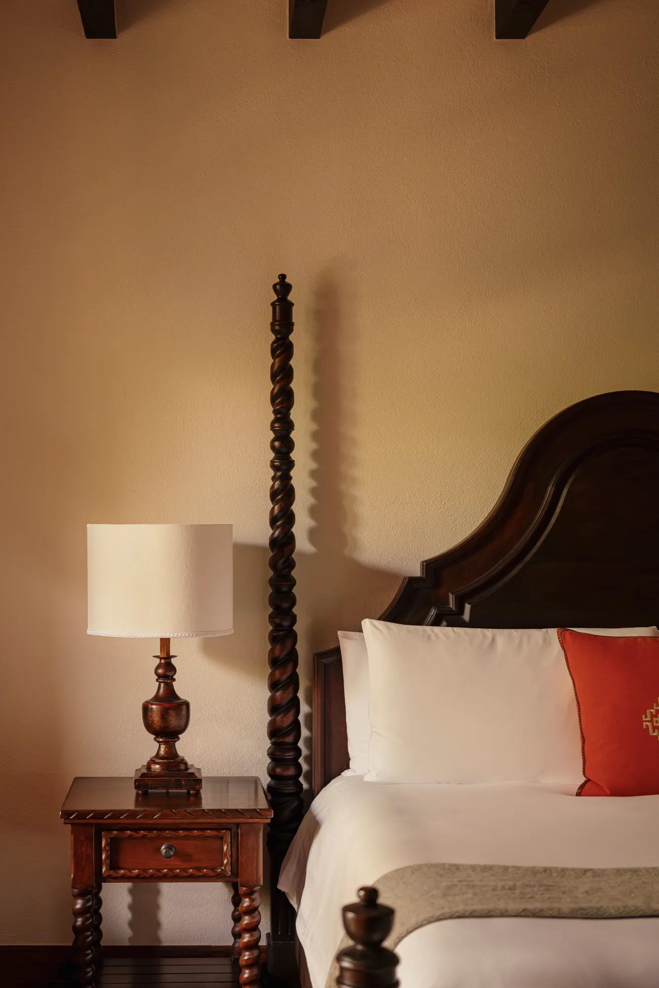 Elegant Colonial Room at Rosewood San Miguel de Allende featuring a king bed, handcrafted furniture, private balcony, and warm natural light.