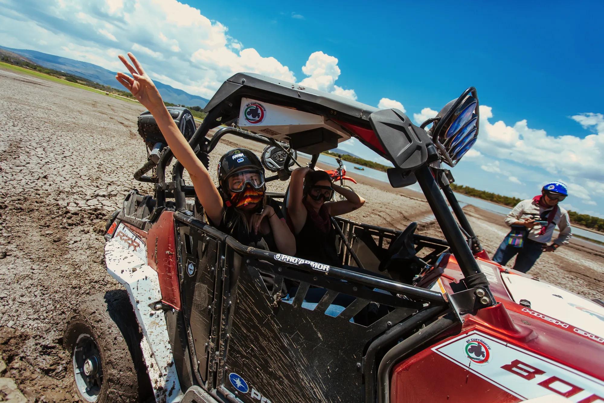All-terrain vehicle driving through a muddy trail in the countryside near San Miguel de Allende.