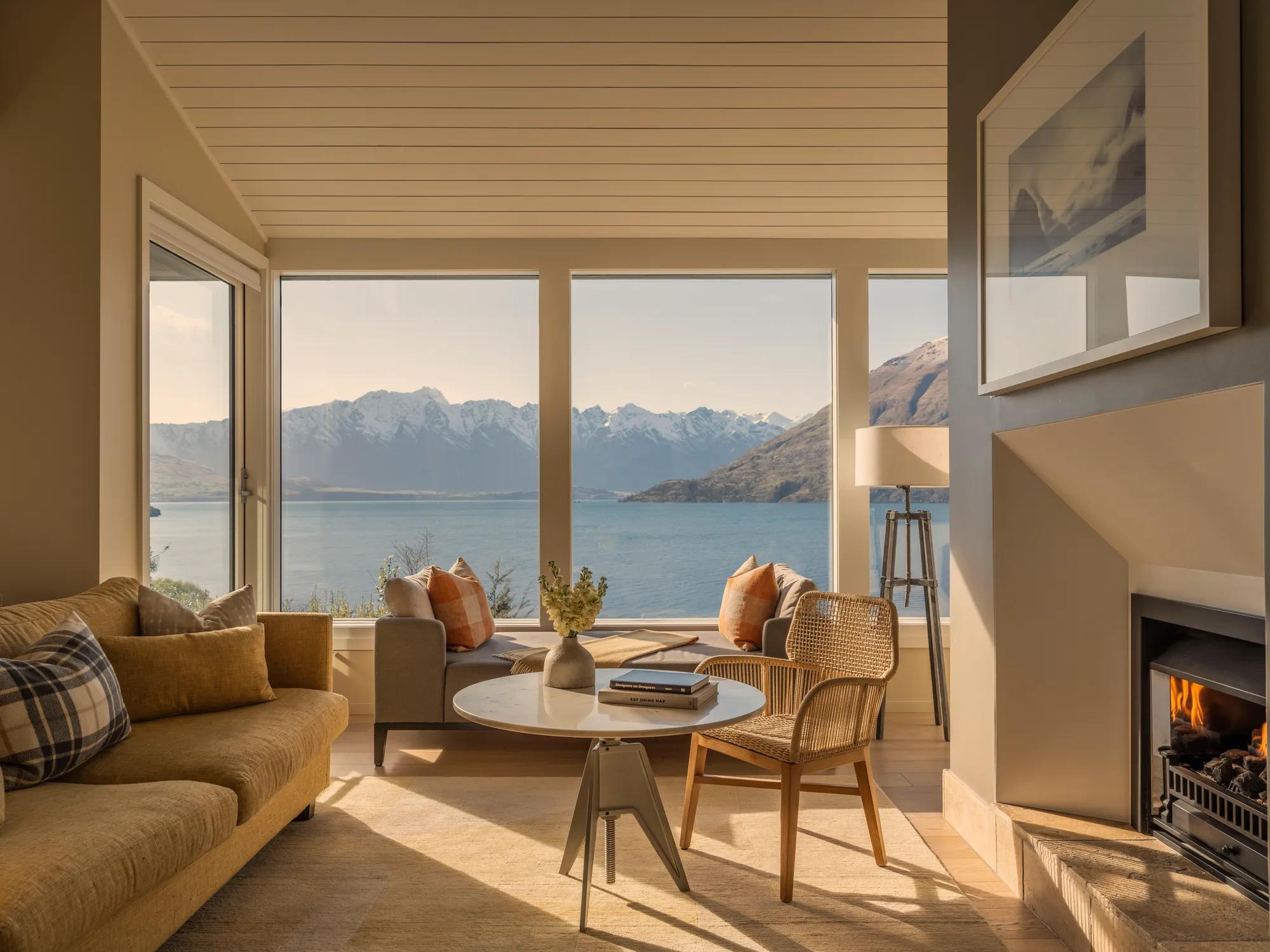 Luxurious standalone bathtub in a four bedroom villa, located next to a window with stunning lake and mountain views.