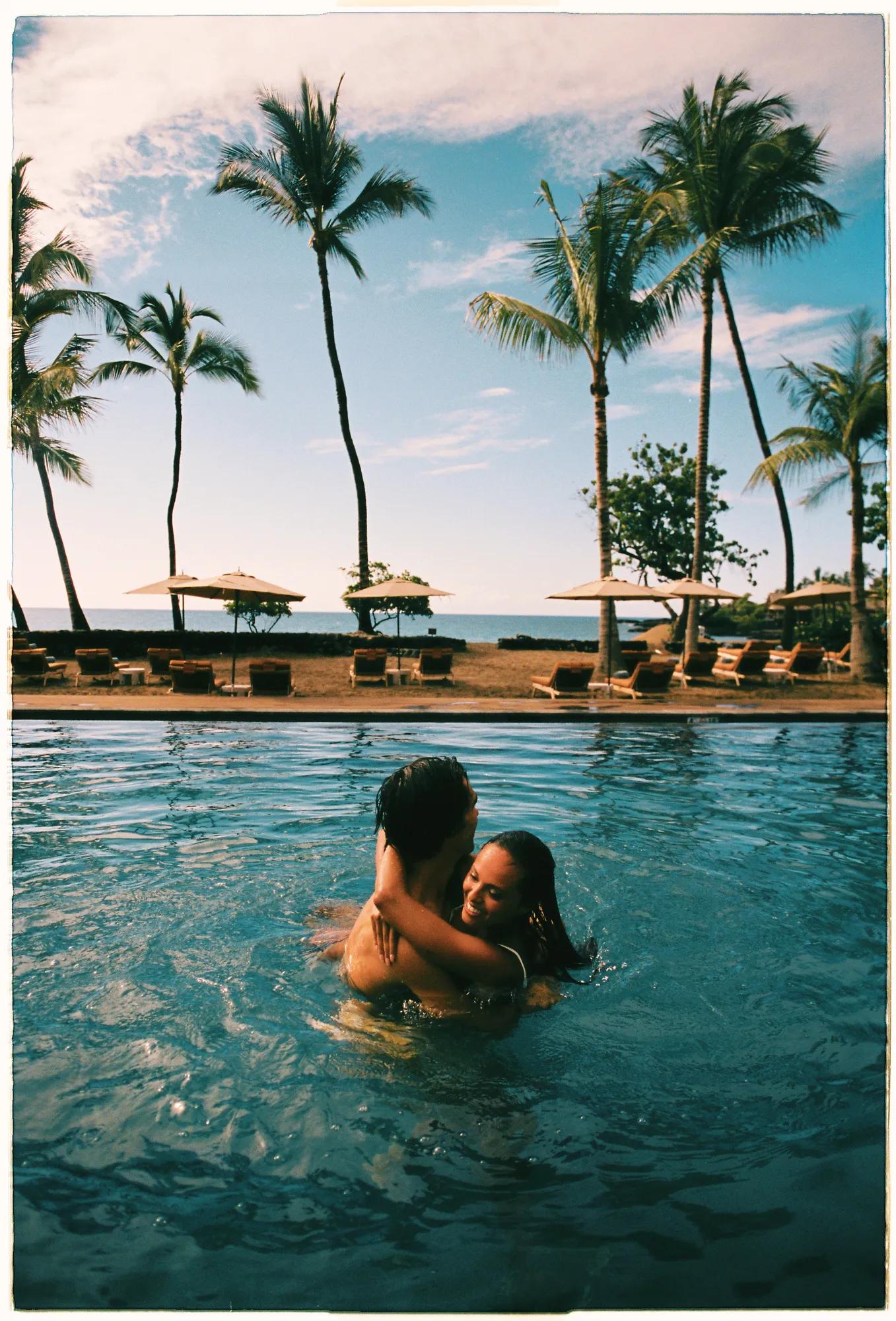 Couple embracing in a pool next to the beach