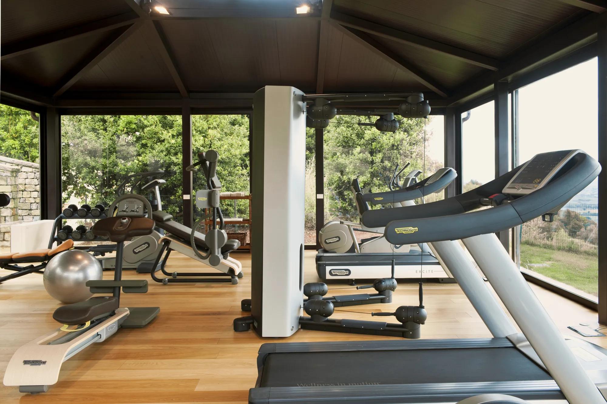 Fitness center 24/7 with Tecnogym training machines at Rosewood Castiglion del Bosco.