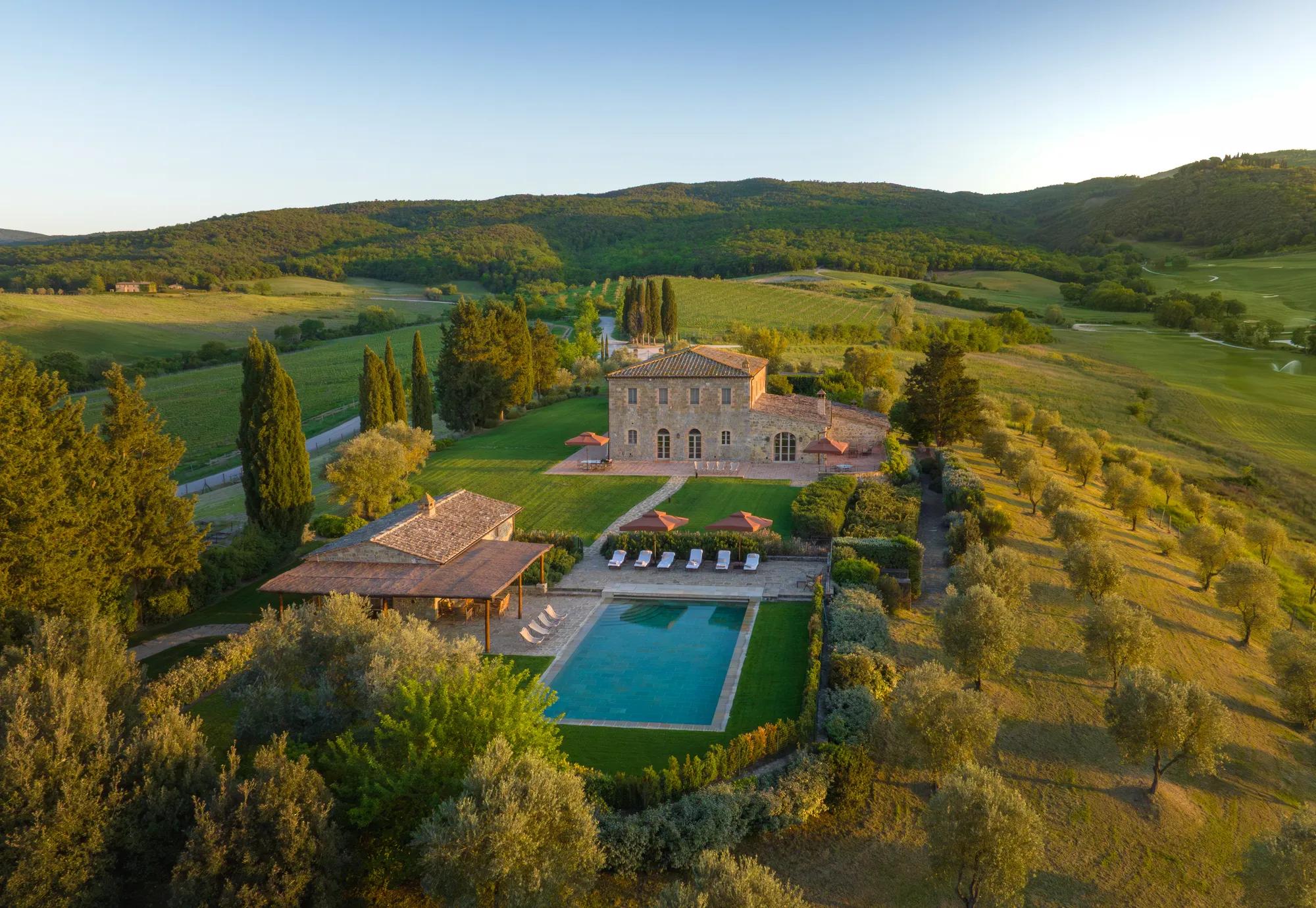 Seating area outside a luxury villa in Tuscany  with scenic countryside views.