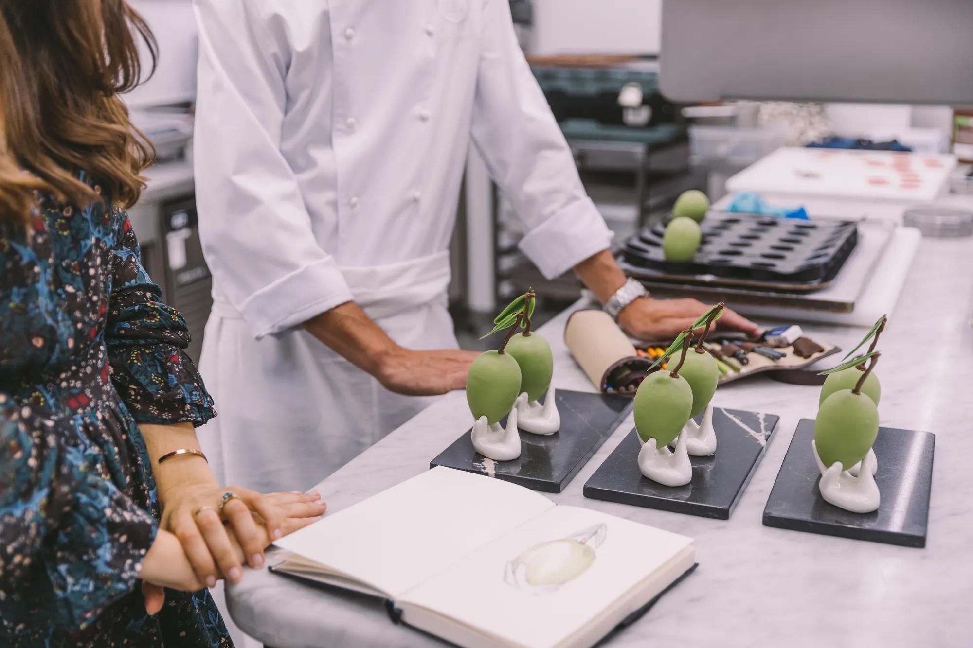 Close-up of guests enjoying cocktails and dishes at a dining table at Rosewood London