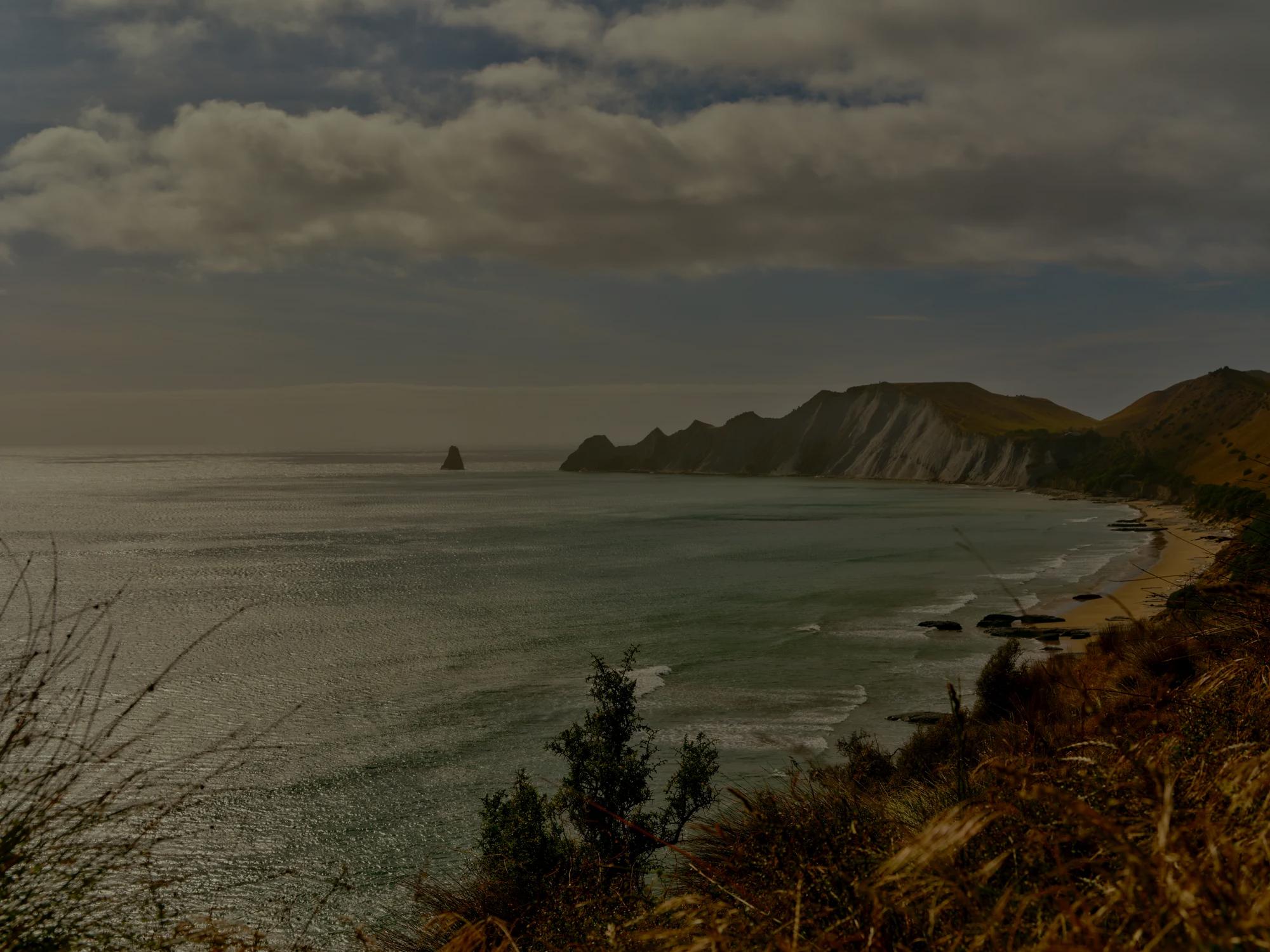 The coastline leading out to the peninsula at Rosewood Cape Kidnappers including a white sand beach and rugged cliffs.