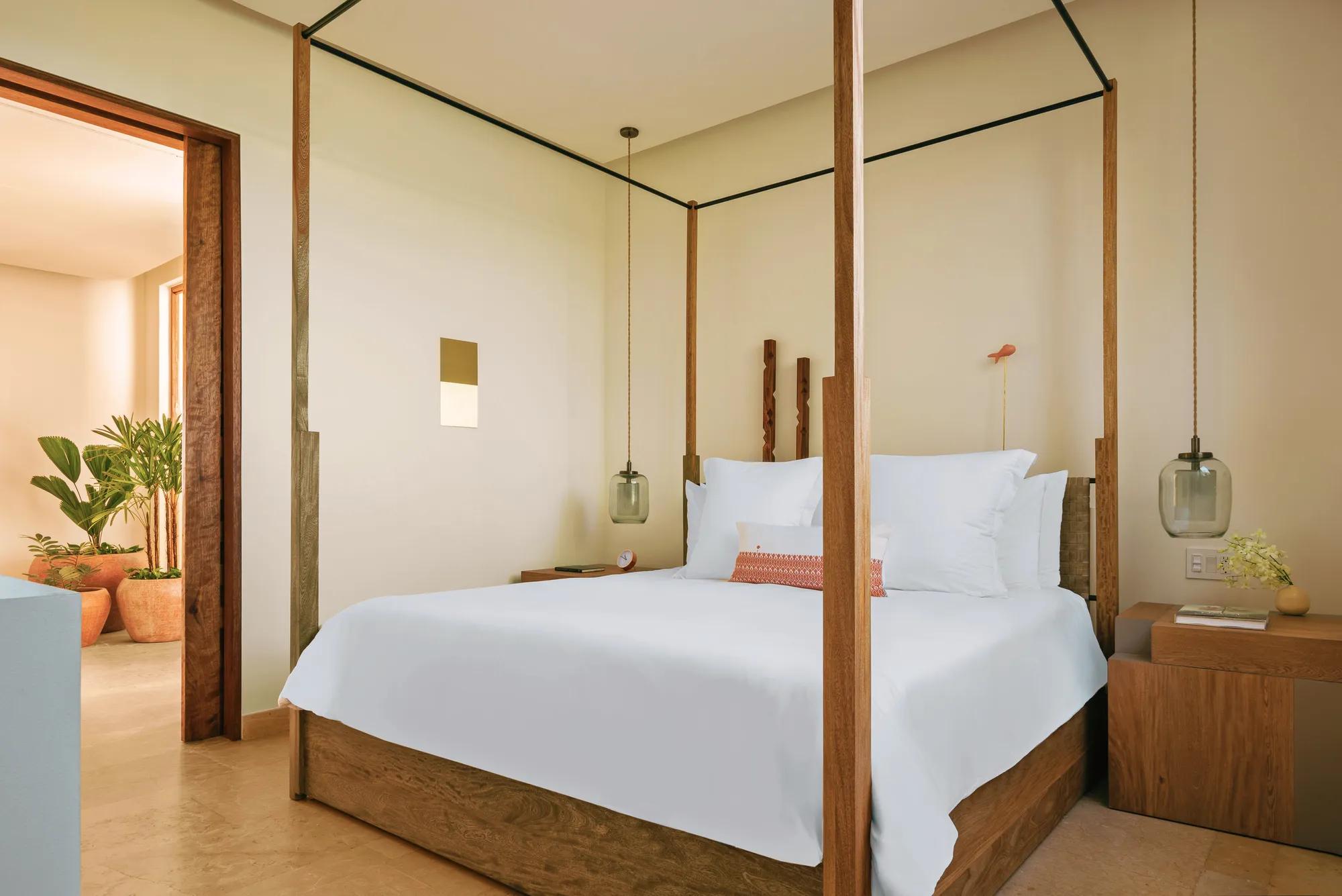 Suite with a king-size bed and two nightstands on either side, featuring minimalistic decor and a serene ambiance.