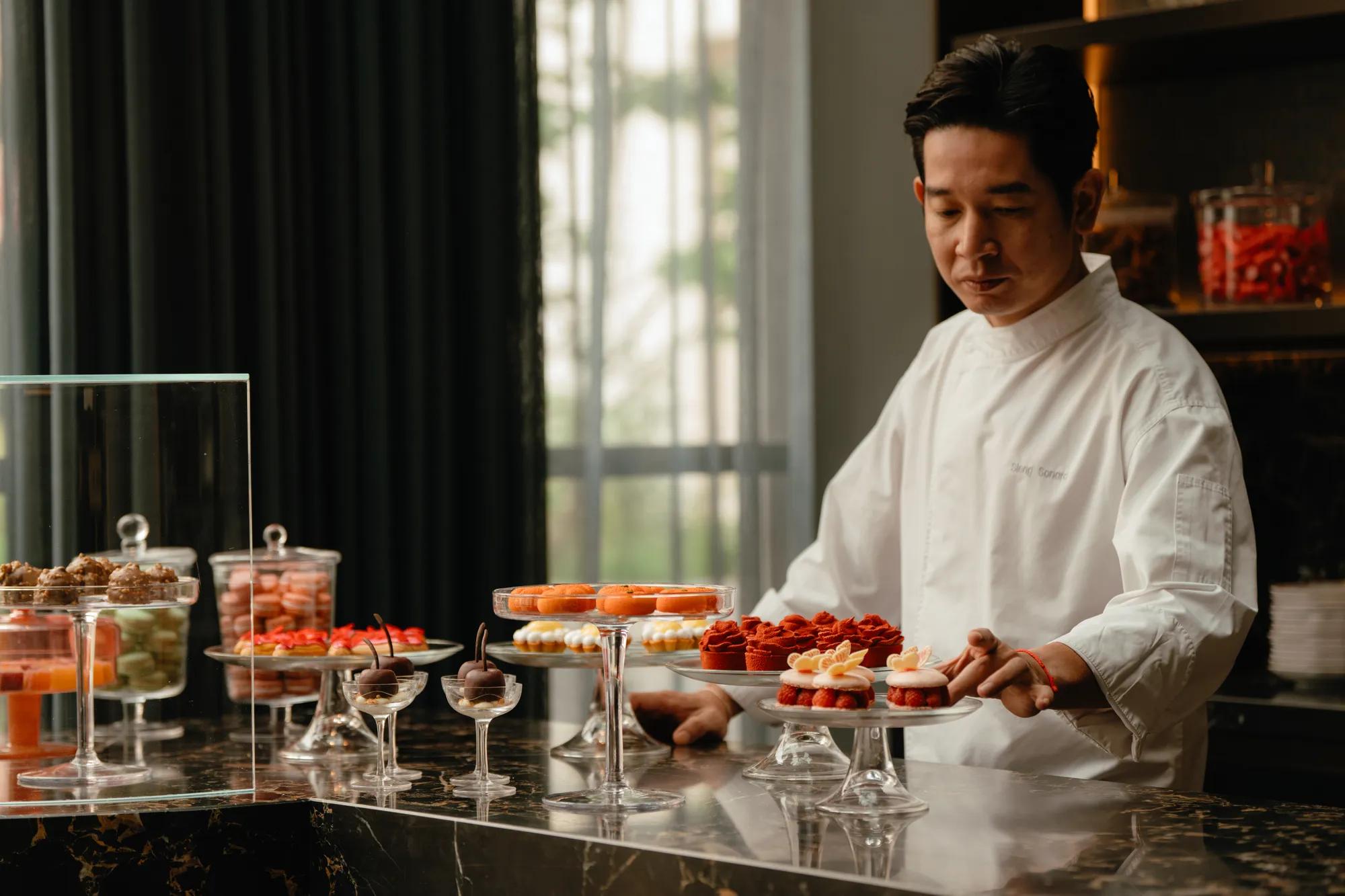 Pastry chef along side Afternoon Tea buffet