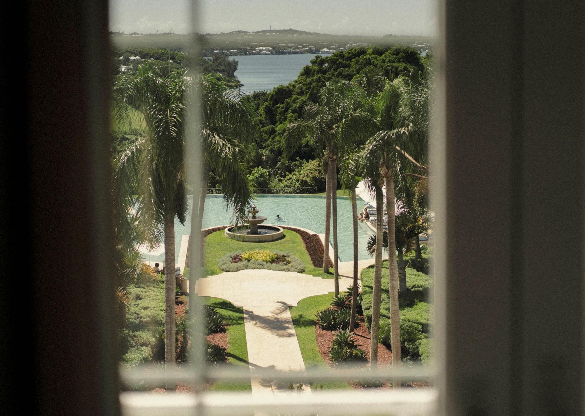 View of Bermuda's coastline and green landscape and pool.