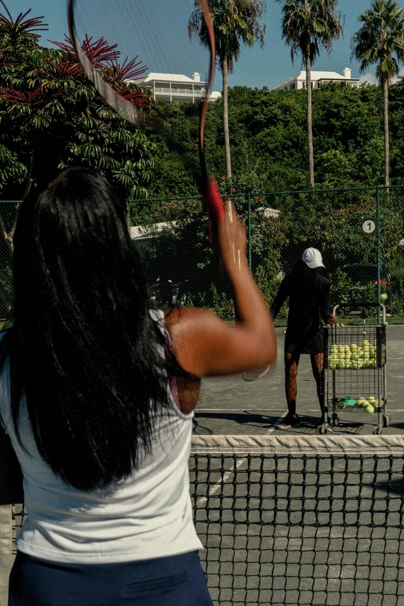 Woman hitting tennis balls during a tennis clinic