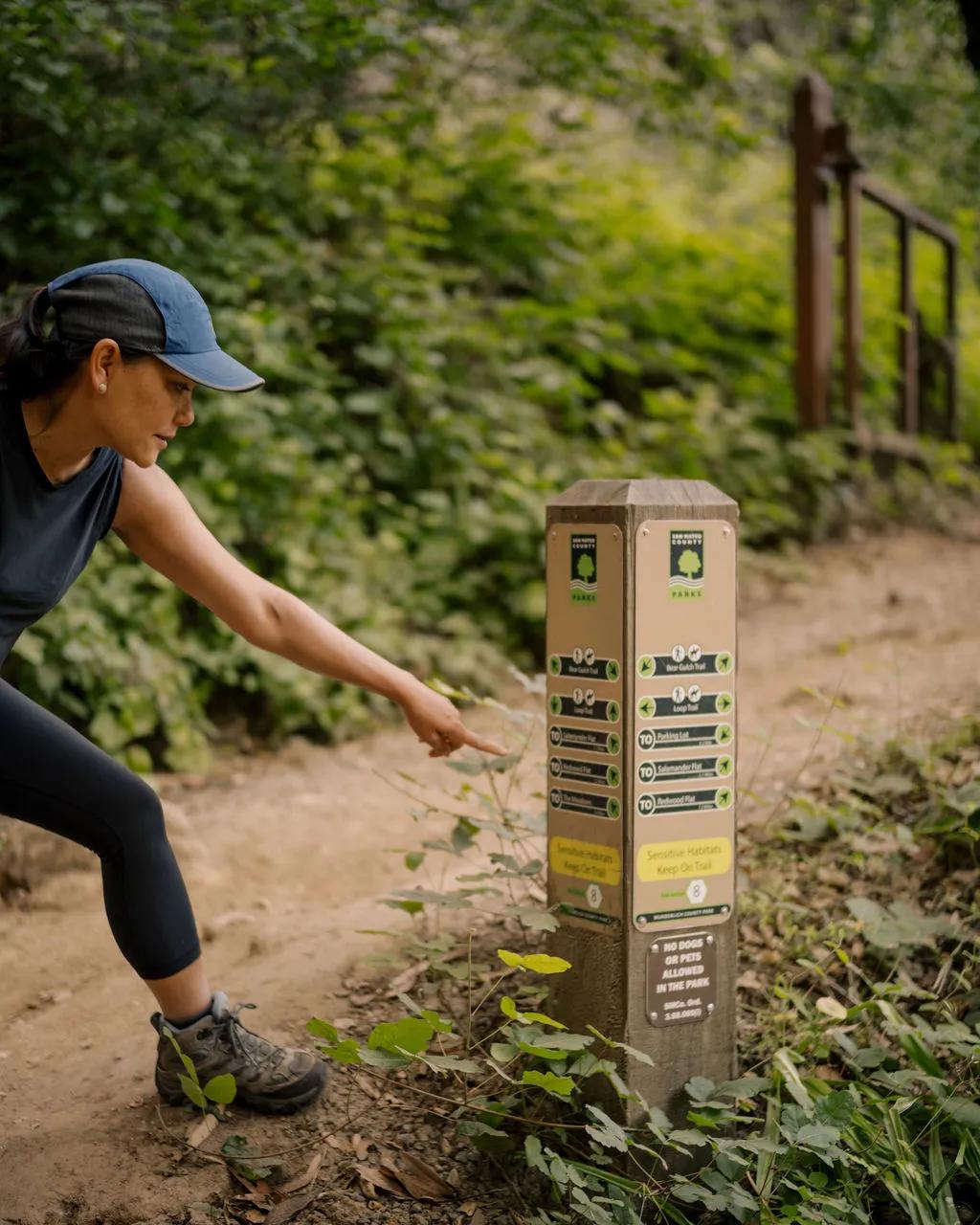 Experienced hiker pointing to trail map