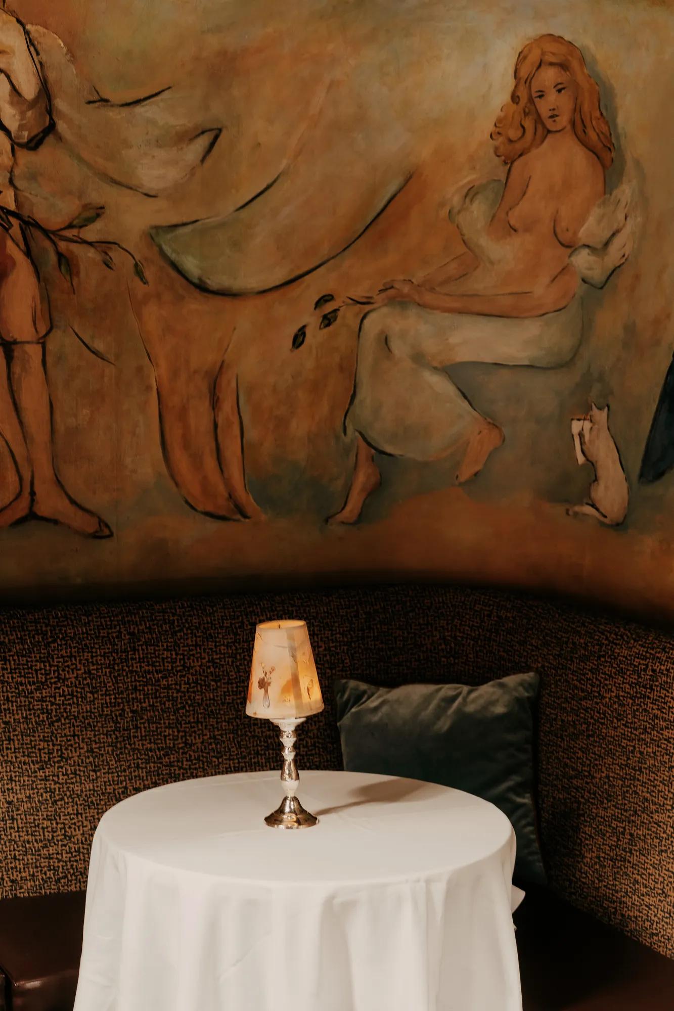 A jeel box supper club with 90 seats decorated by the hand-painted murals by Marcel Vertes, an Oscar winning costume designer. 