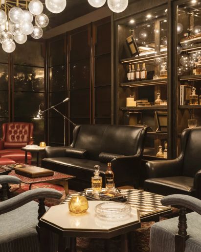 Hotel lounge in Phnom Penh  with leather seating and  globe chandeliers. 