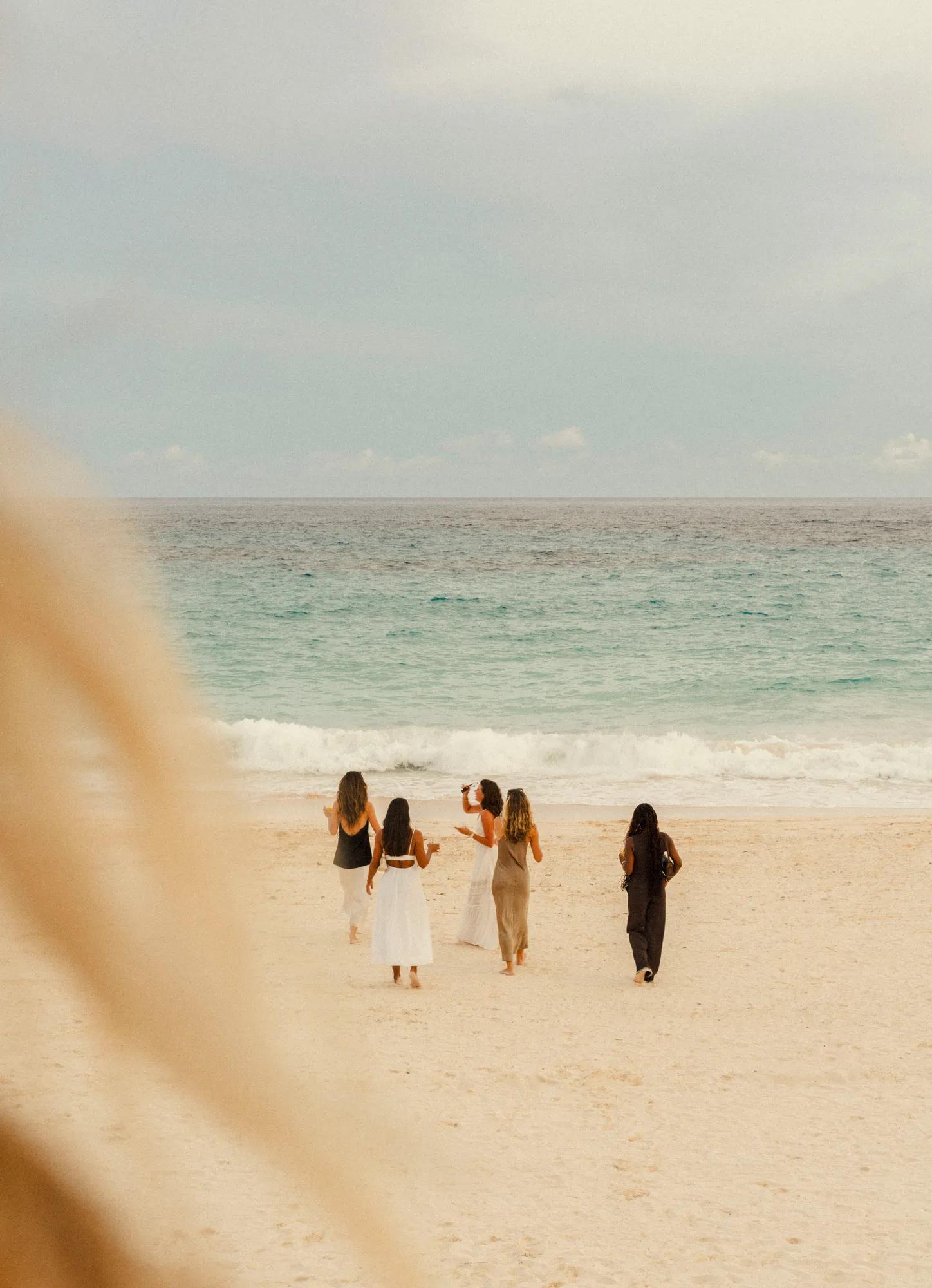 Girls walking on the beach at the beach club