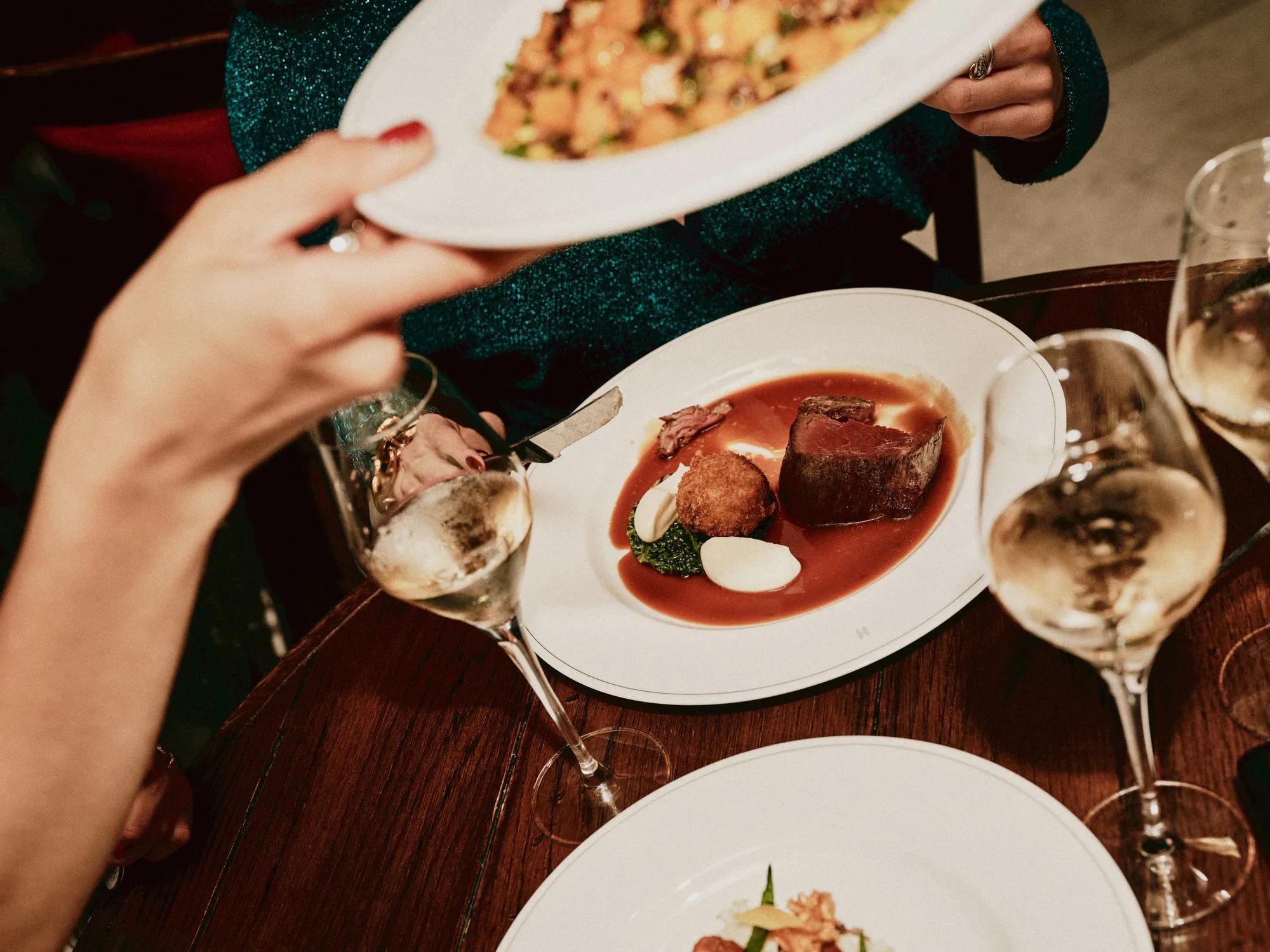 Guests sharing a meal within one of Rosewood London's restaurants 