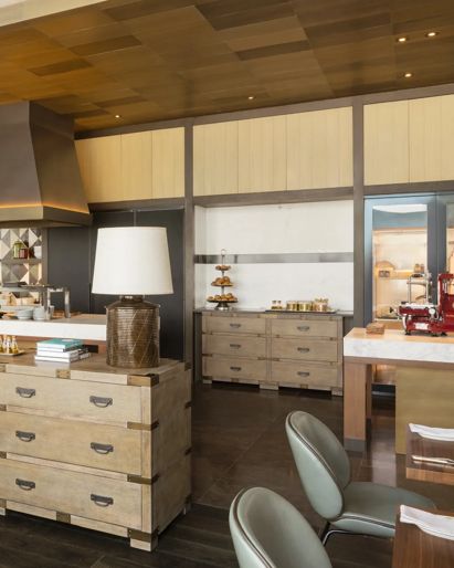 Luxury hotel breakfast area  with an open kitchen and  wooden buffet station. 