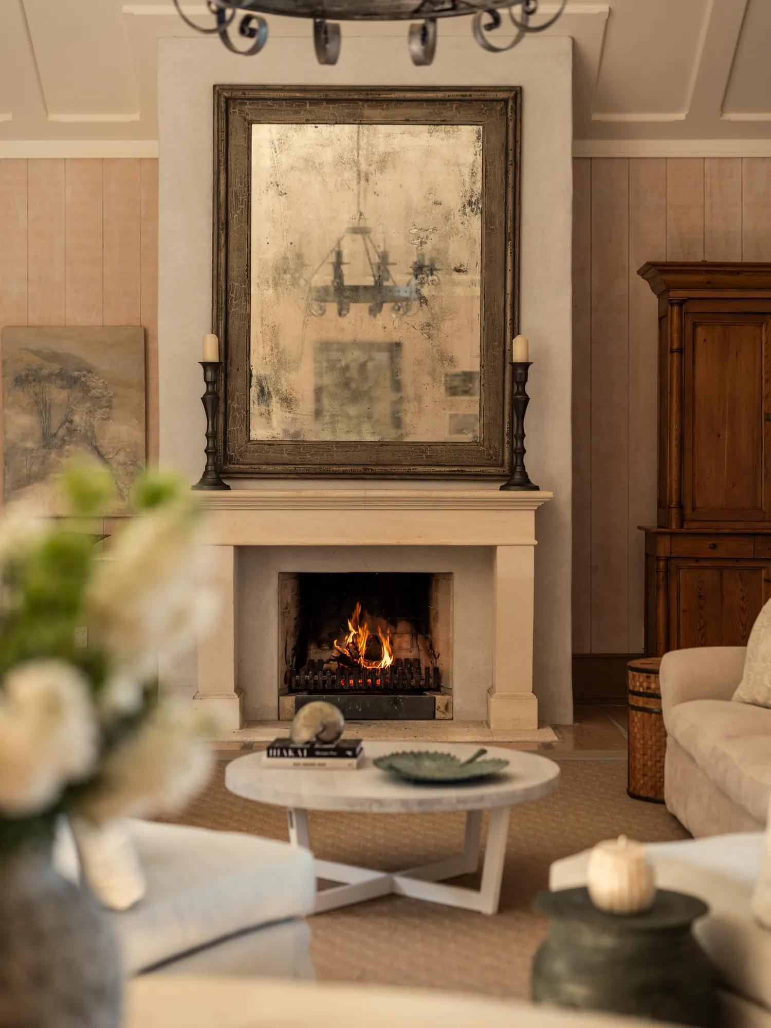 Sitting area in a luxury villa with open fire and elegant furnishings. 