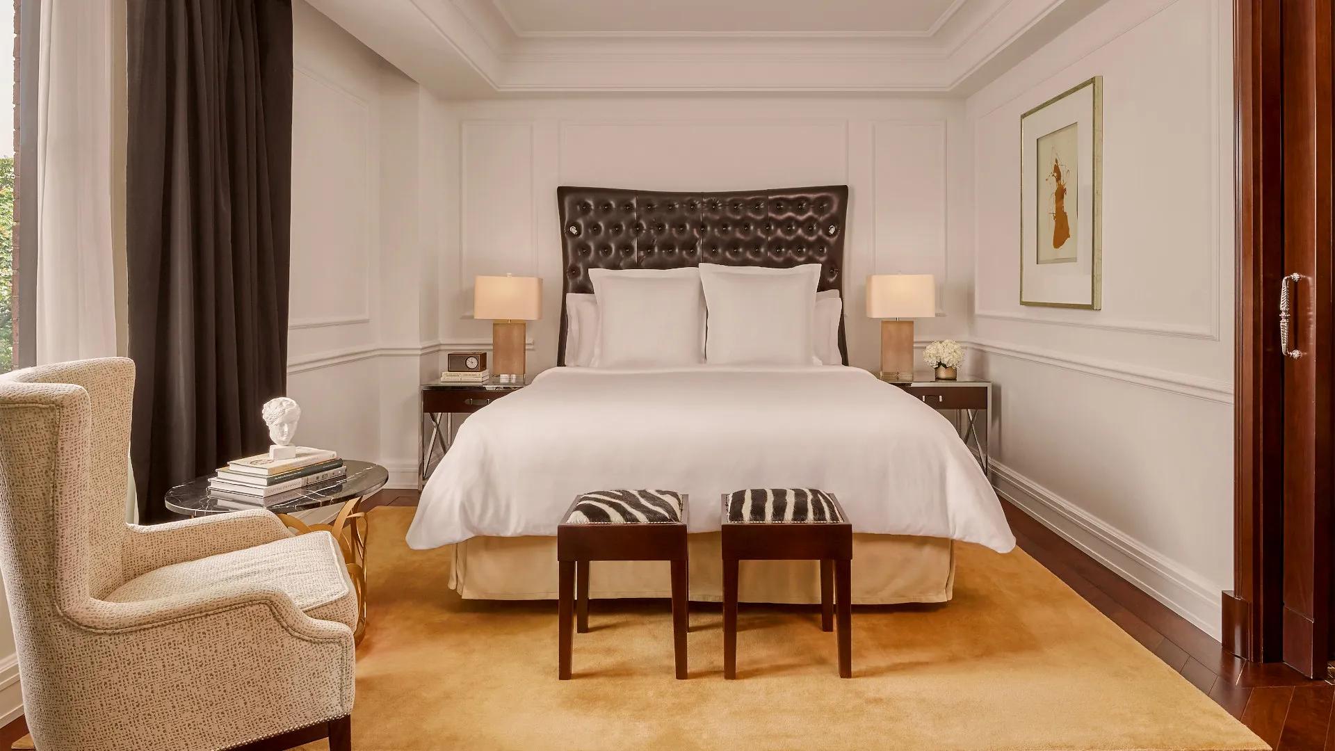 Luxury D.C. hotel Presidential Suite living room with fireplace and flat-screen TV.