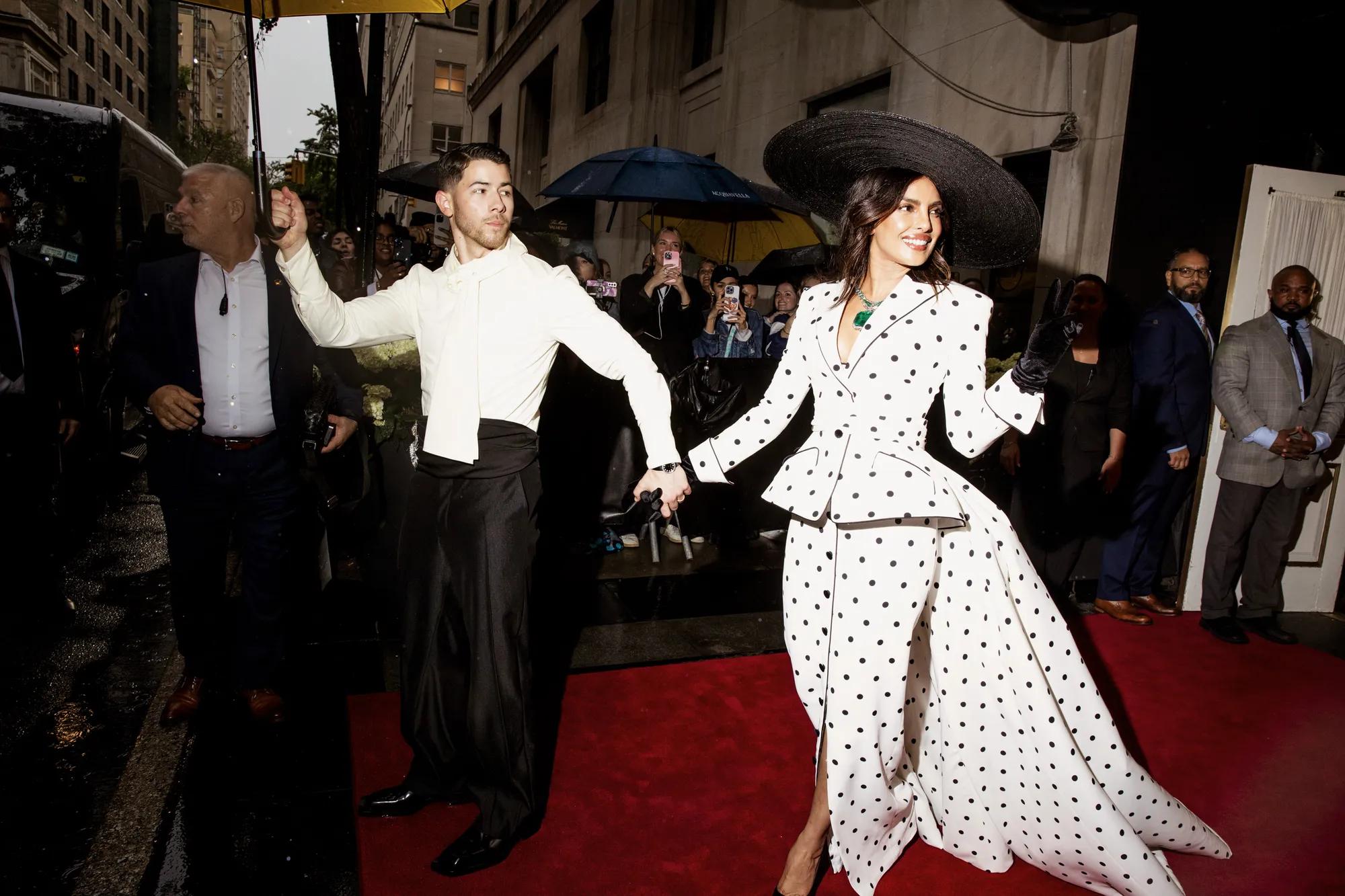 Couple walking out of the Madison & 76th street entrance. 