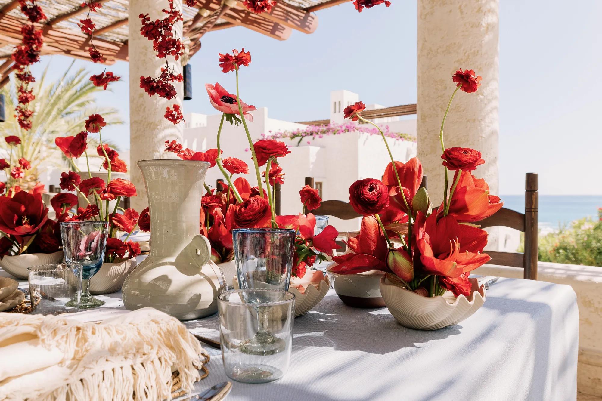 Elegant ocean-view dinner table at Las Ventanas al Paraíso, set with fine china and crystal glassware, offering a panoramic view of the Sea of Cortez
