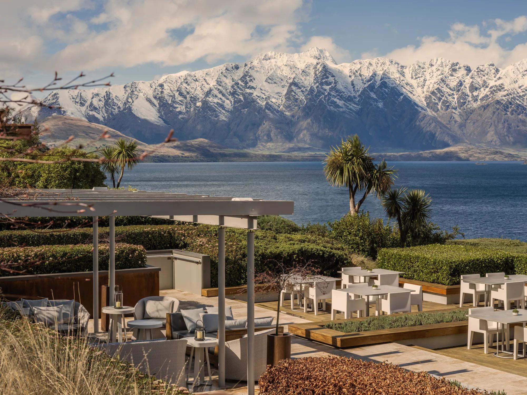 Overlooking the outdoor dining set up on the Remarkables Terrace with views of Lake Wakatipu and snow covered Remarkables Mountain Range.