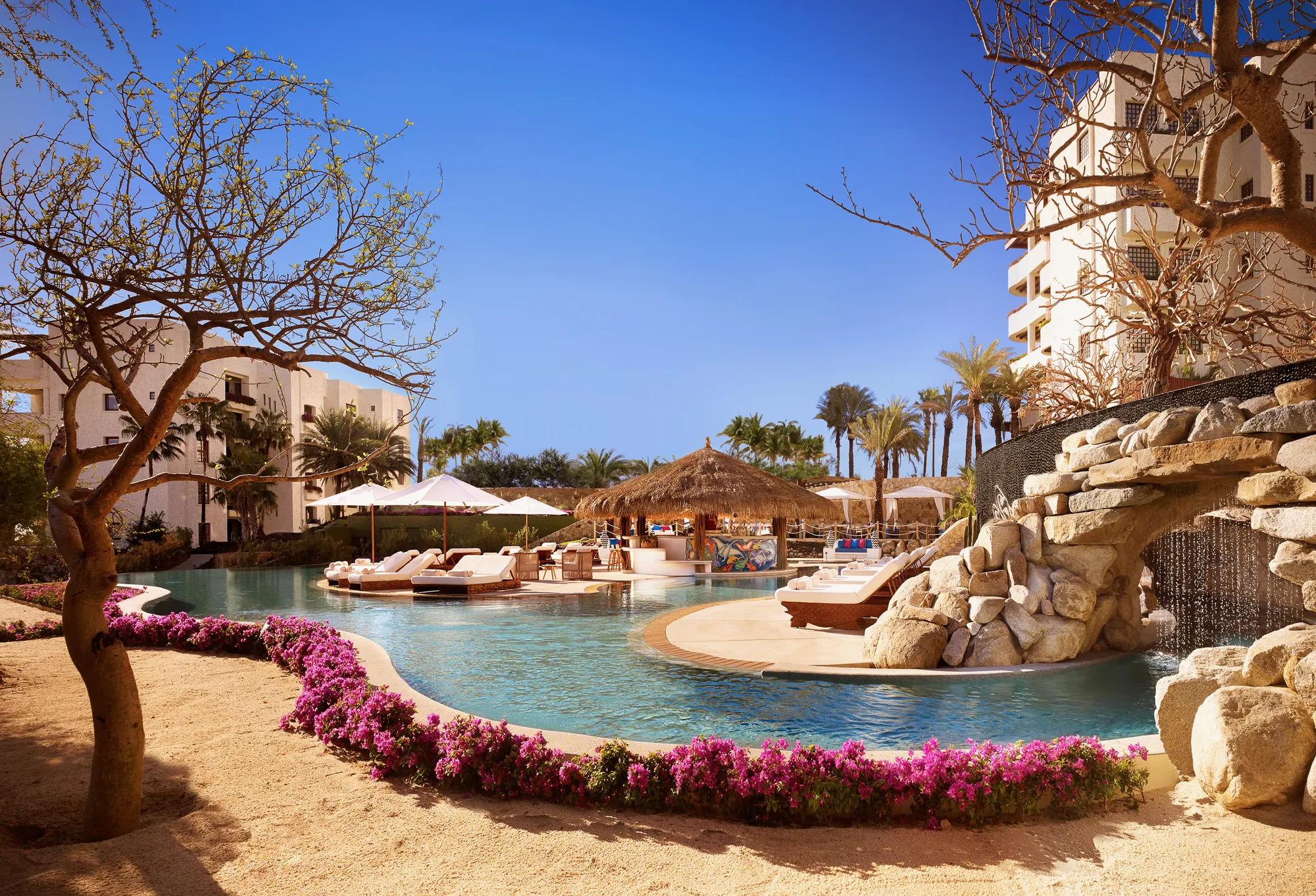 The Oasis Pool at Las Ventanas al Paraíso, showcasing a 180-foot infinity-edge pool, lazy river, and lush lounge areas