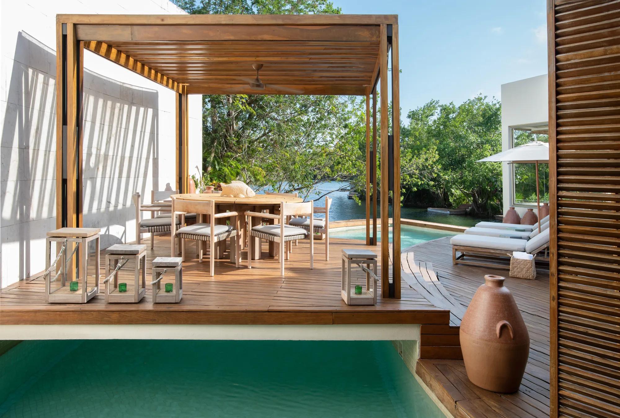 Exterior view of the Lagoon Presidential Suite, showcasing the terrace set between the tranquil lagoon and lush jungle surroundings. 