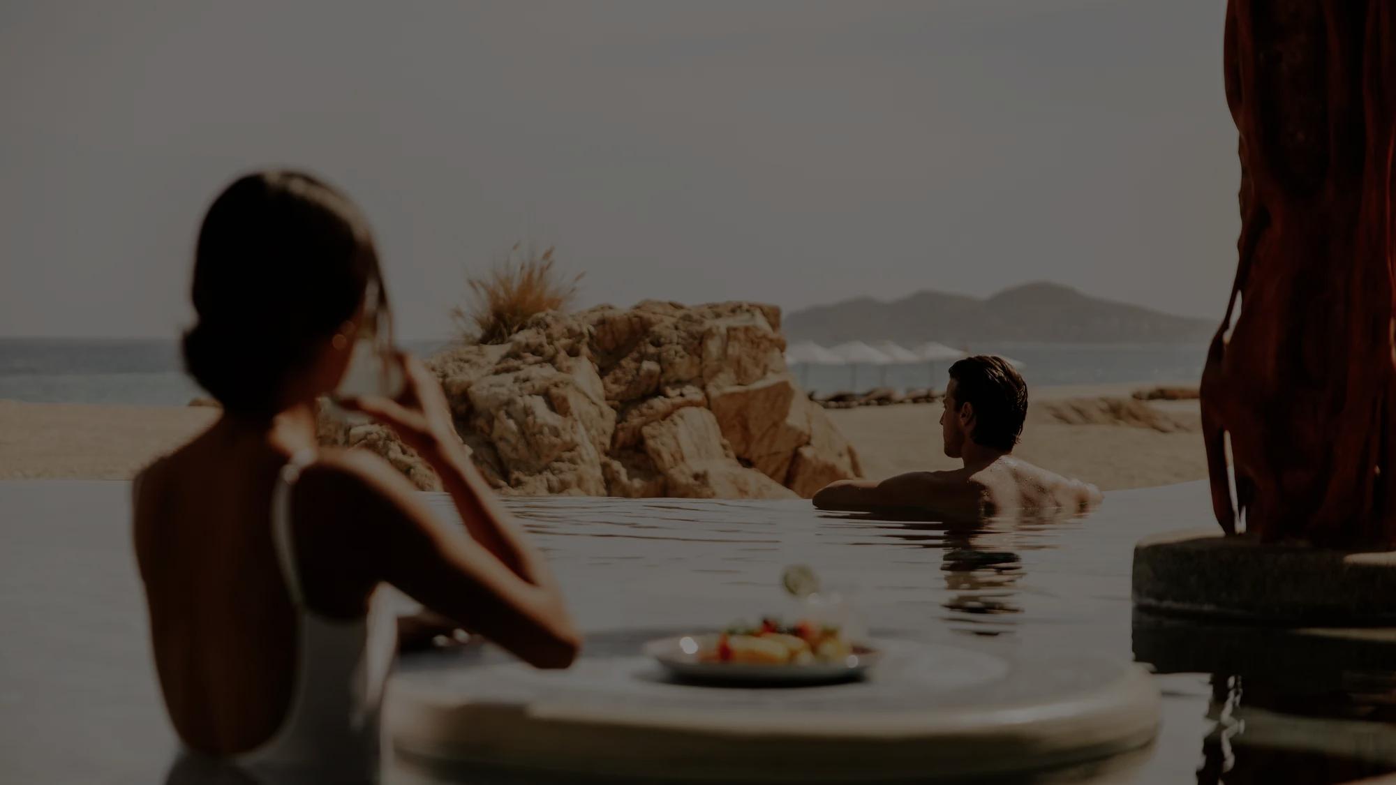 Couple in a private beachfront infinity pool