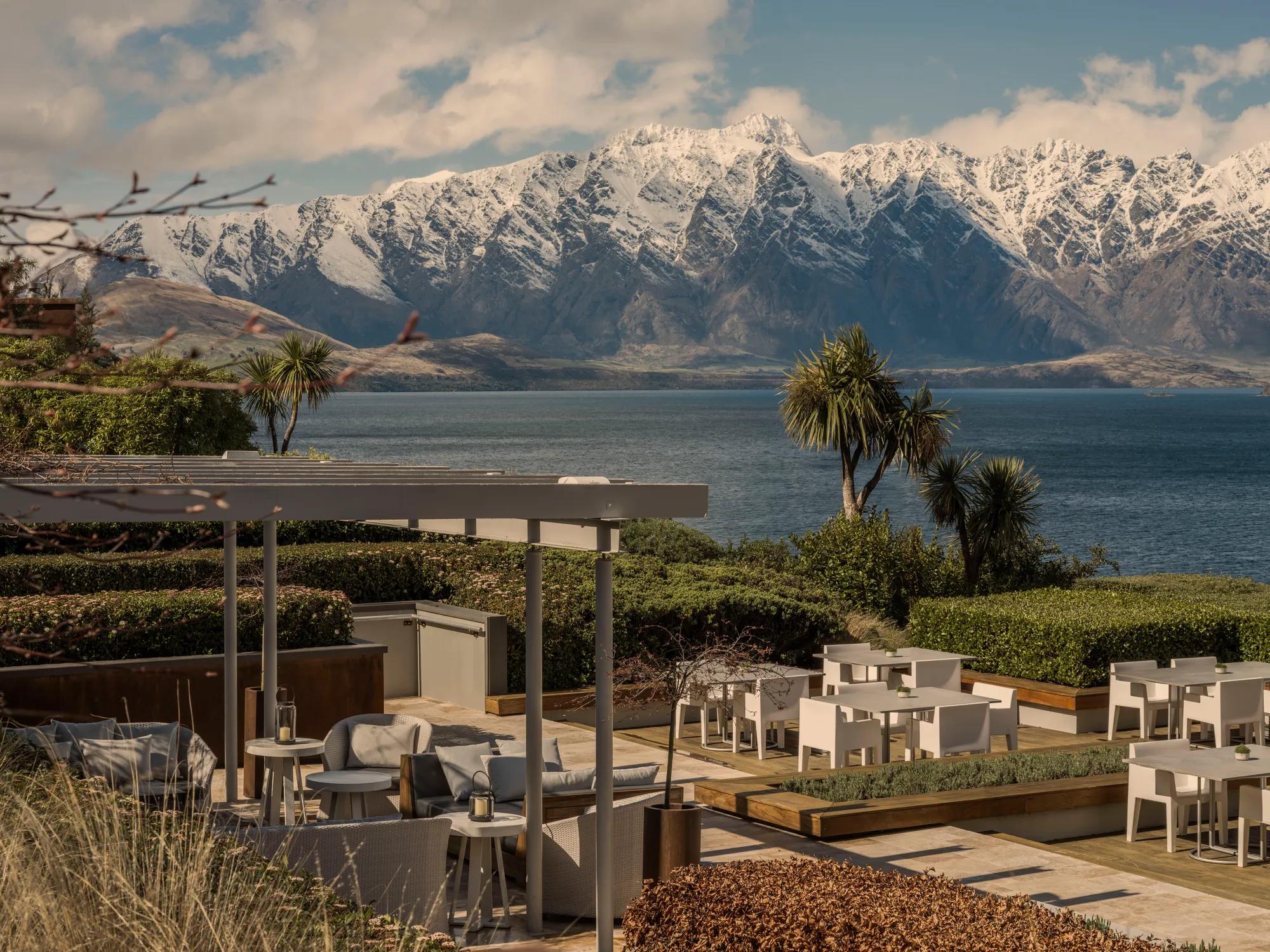 Overlooking the outdoor dining set up on the Remarkables Terrace with views of Lake Wakatipu and snow covered Remarkables Mountain Range.