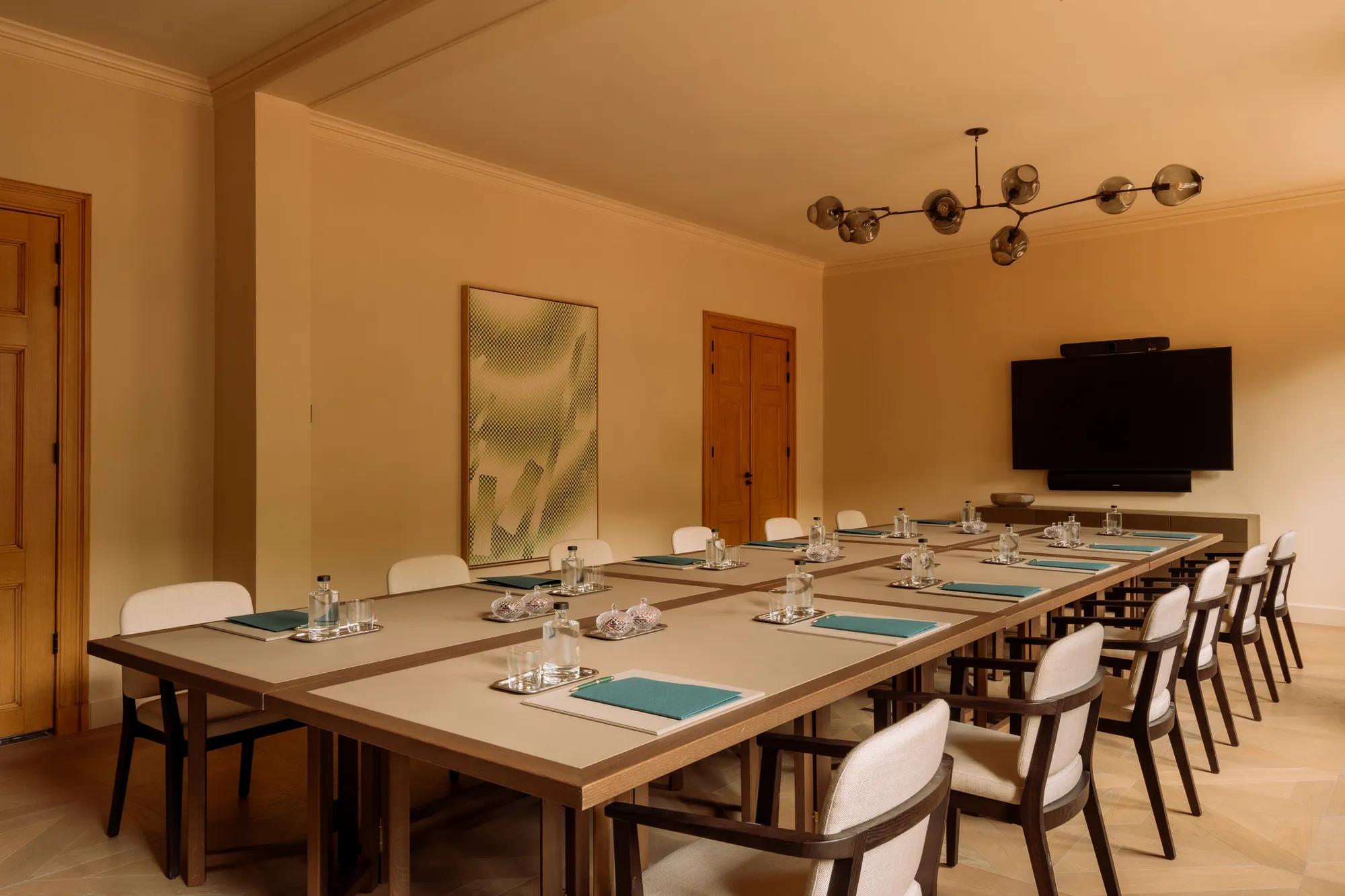 Meeting room with table and chairs with screen