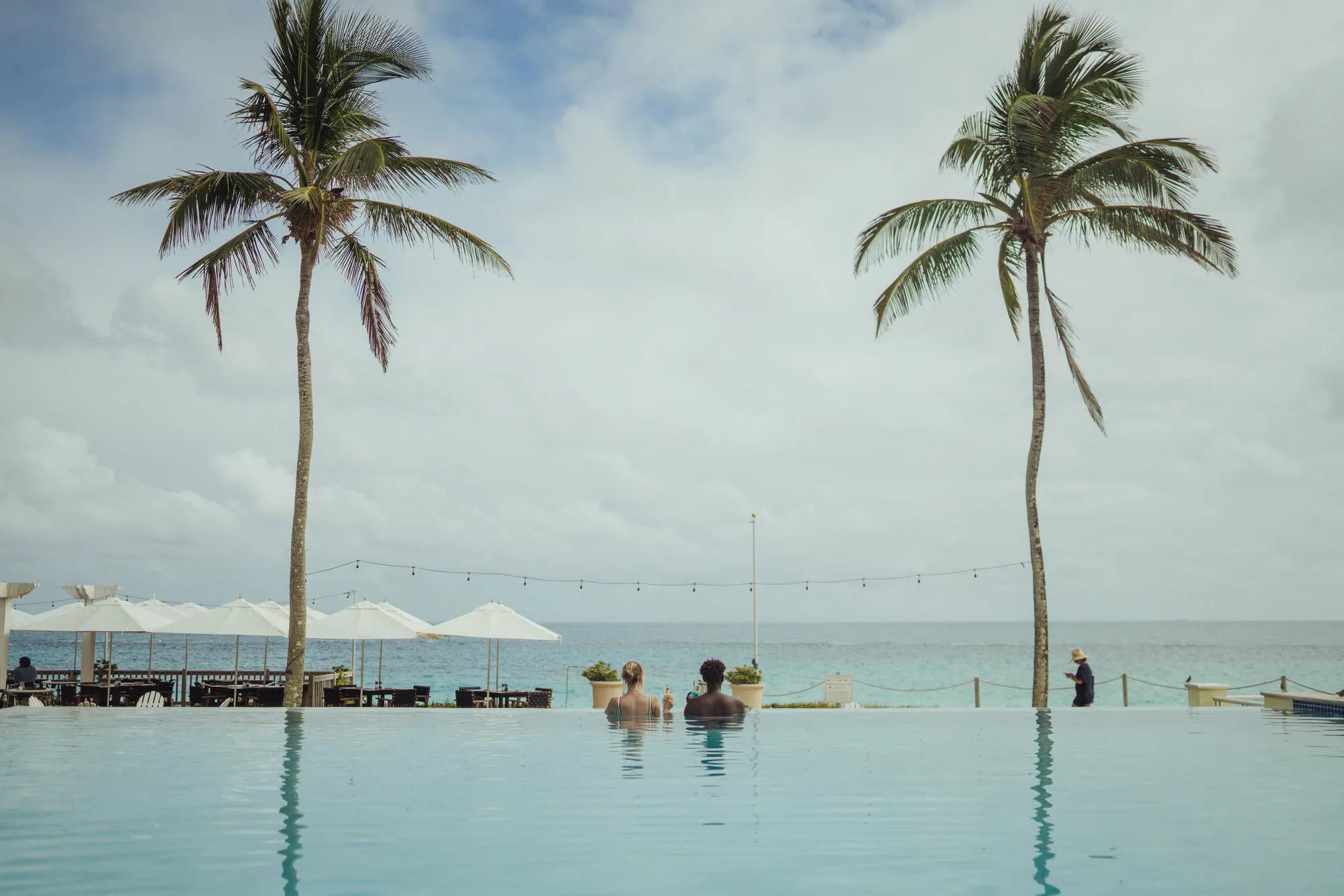 Couple in Horizon pool looking out at the ocean