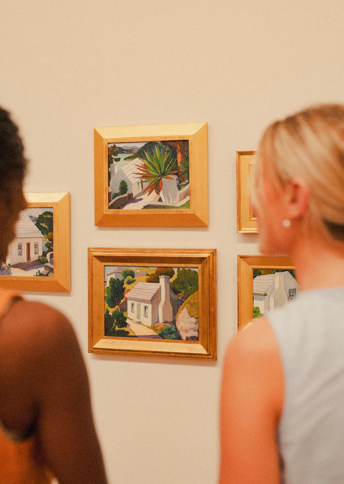 Two people looking at paintings at Masterworks Museum