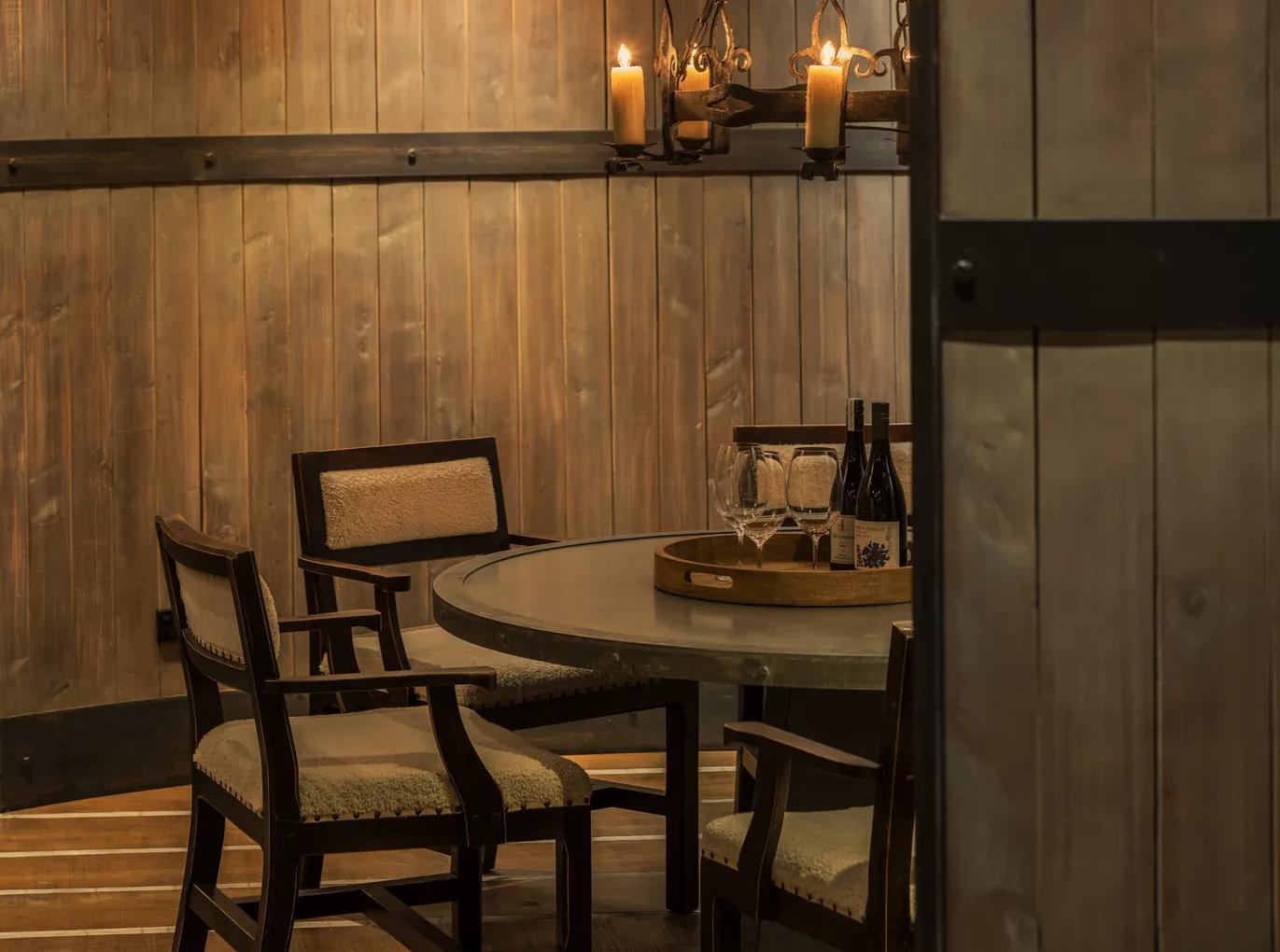 Beautifully set table in a private dining room with refined countryside interiors and open fire